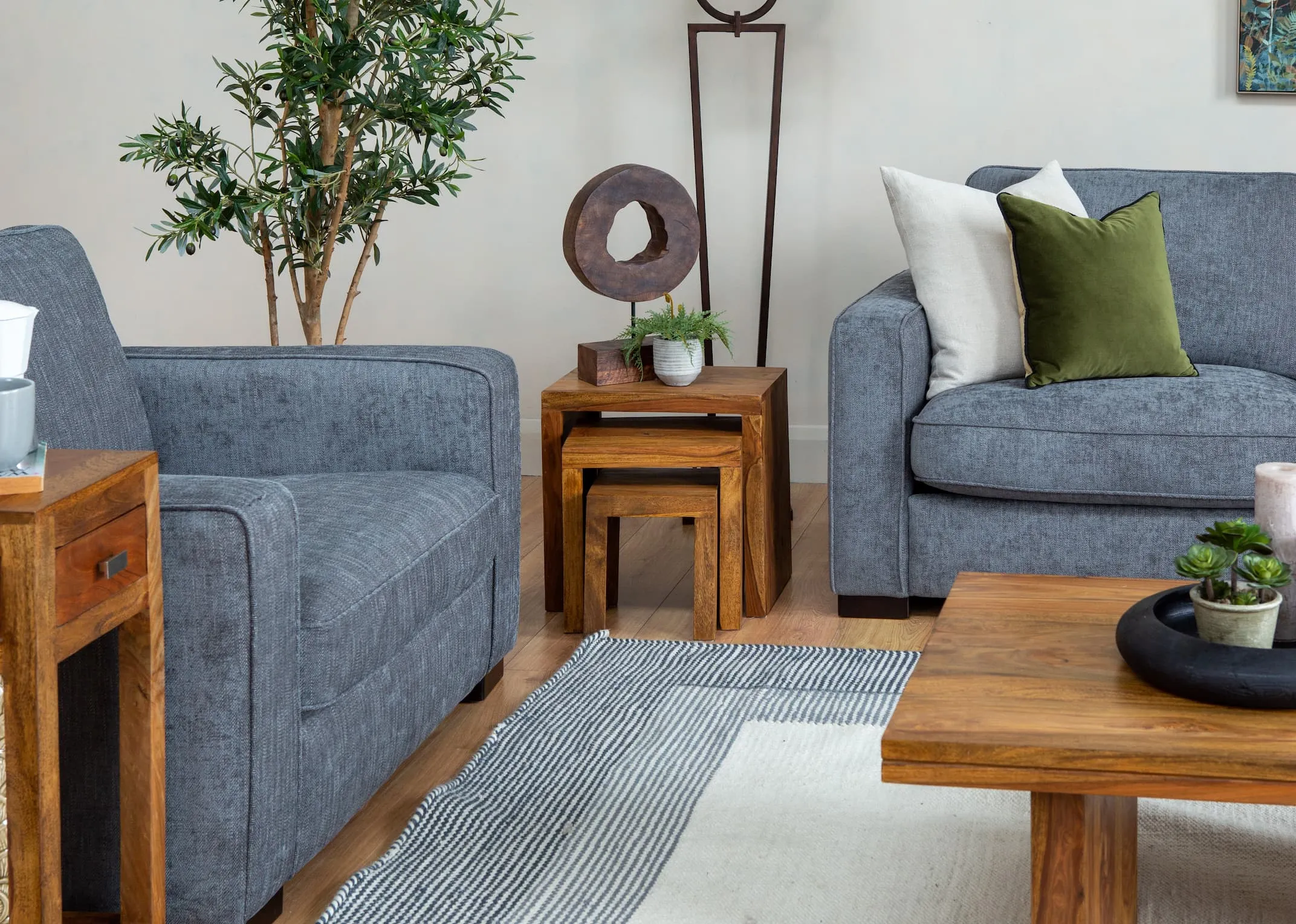 A lifestyle image of the Darwin Chaise with India nests with Xerra Ornamant