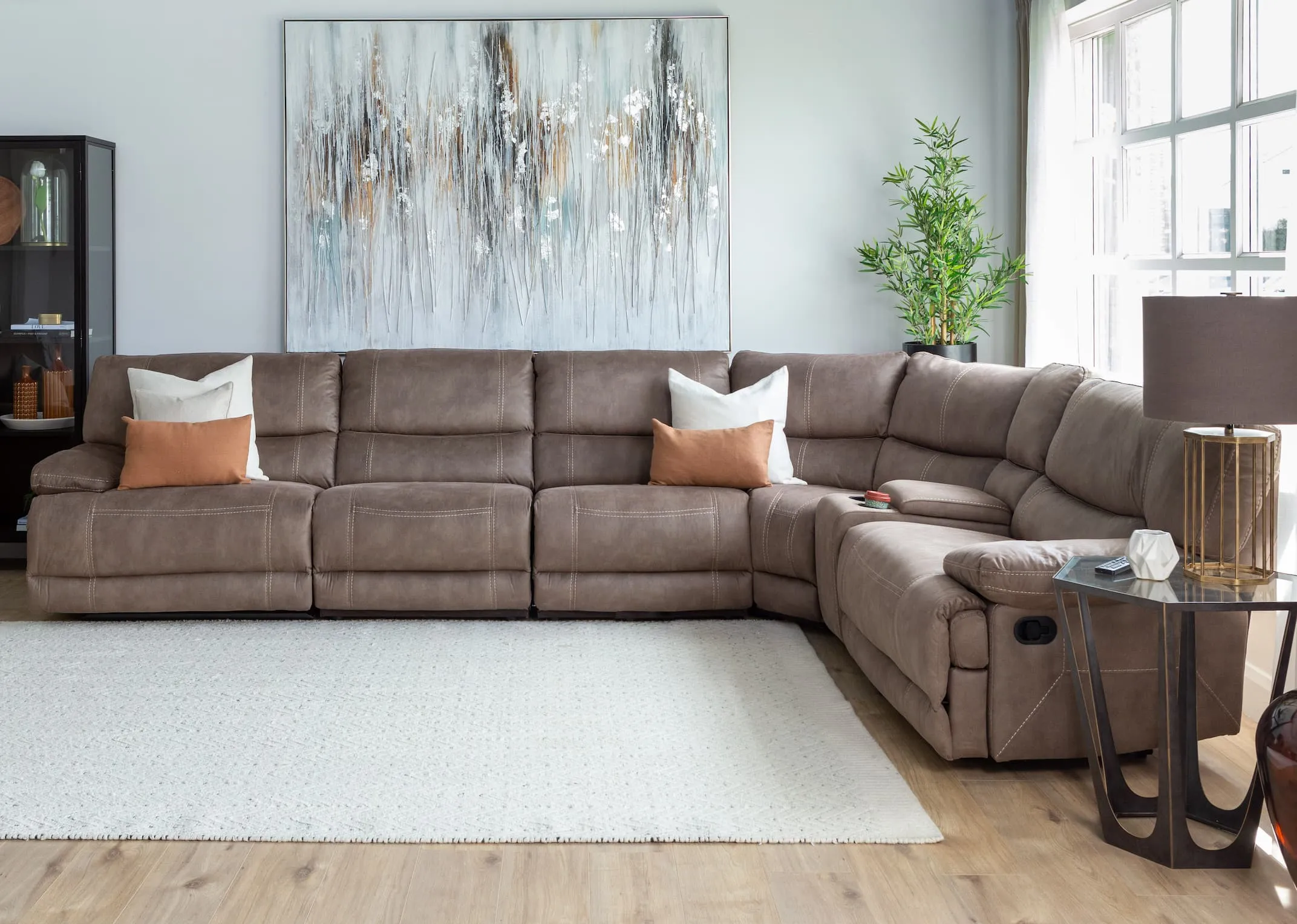 A lifestyle imange of the Baxter Large corner modular sofa with catalan tables and Tones of grey canvas.