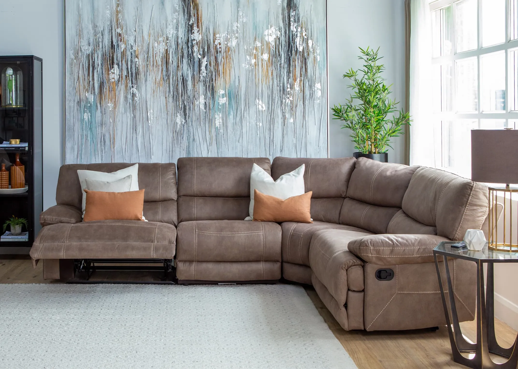 A lifestyle imange of the Baxter small corner modular sofa with catalan tables and Tones of grey canvas.