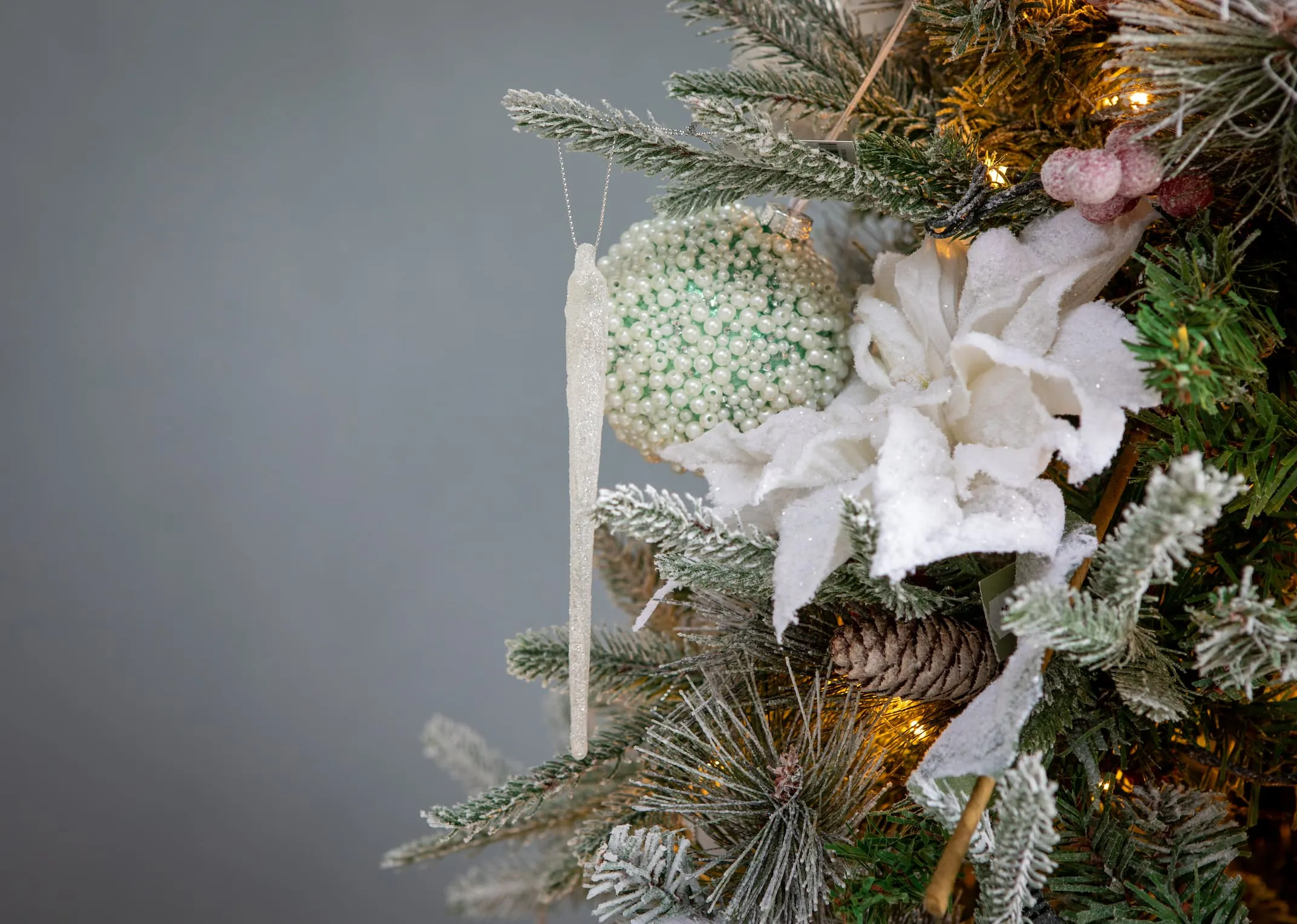 A lifestyle image of the Icicle Ornament hanging on the Vermont tree