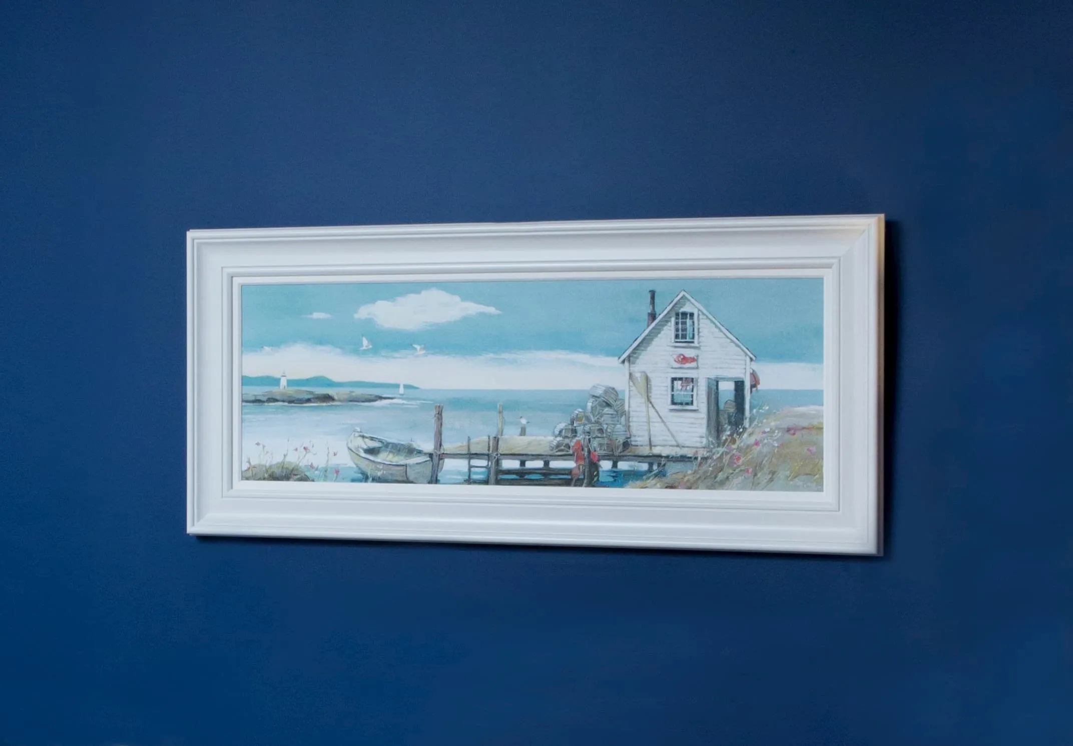 A lifestyle image of Adelene Fletcher's framed print on a blue background available at EZ Living Furniture