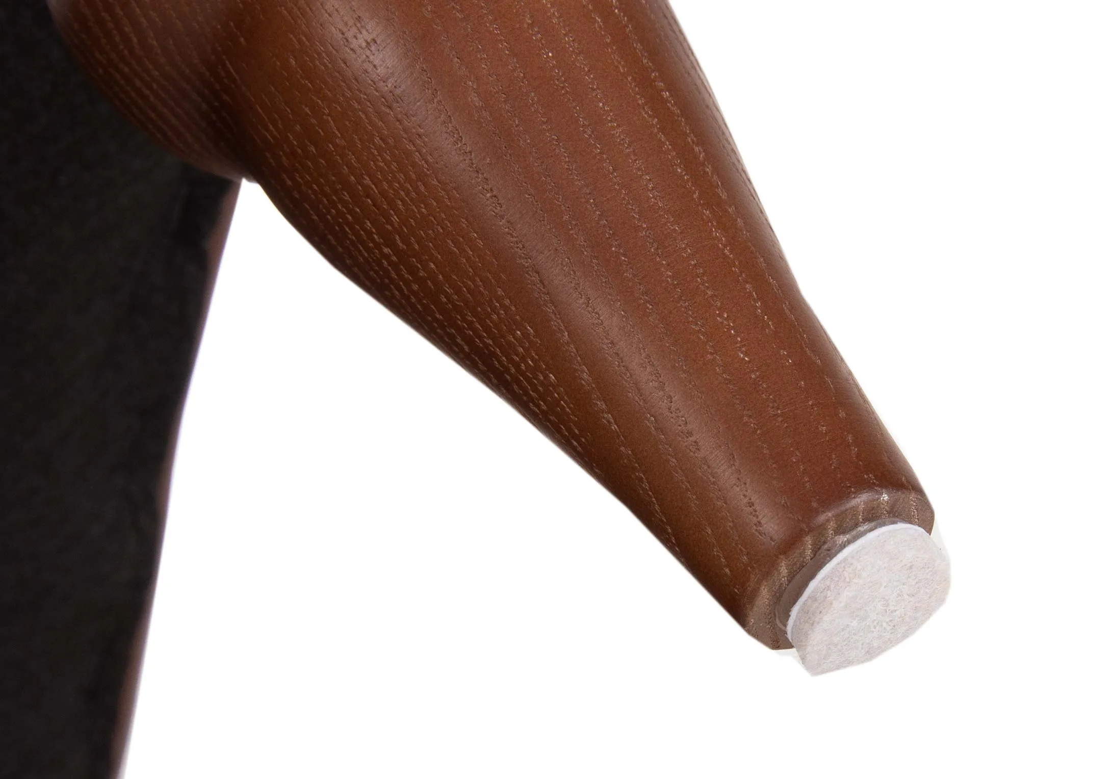 A closeup image of the adhesive pads attached to the foot of a footstool