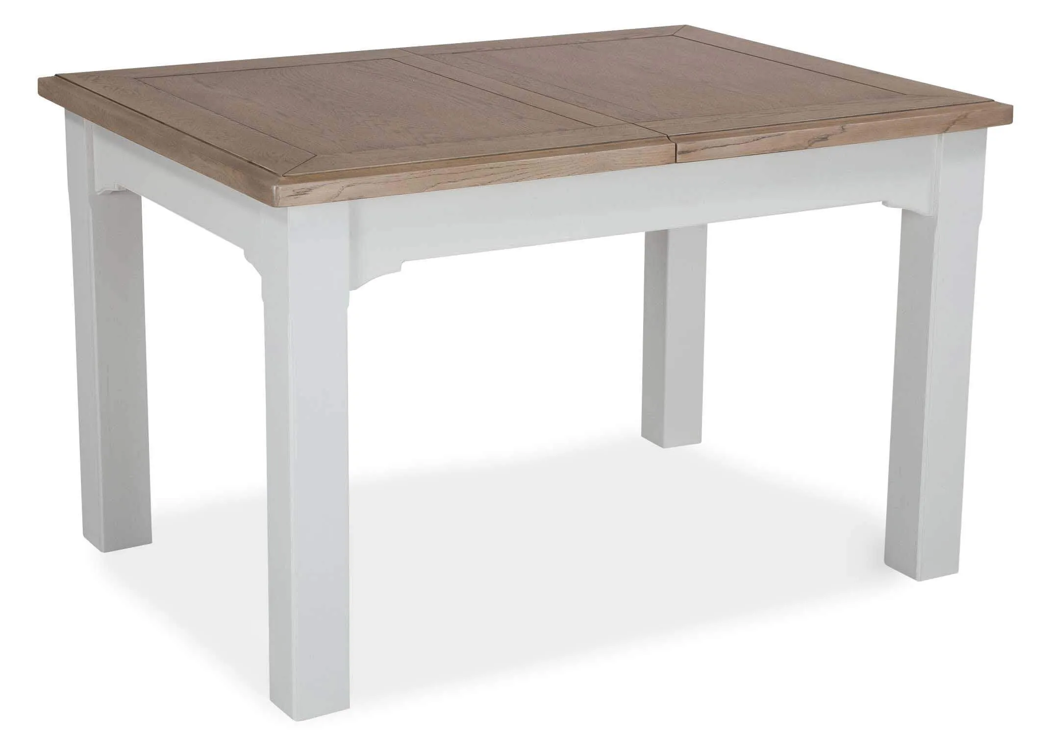 Angled view of the front of the dual coloured solid oak Georgia dining table with leaves extended