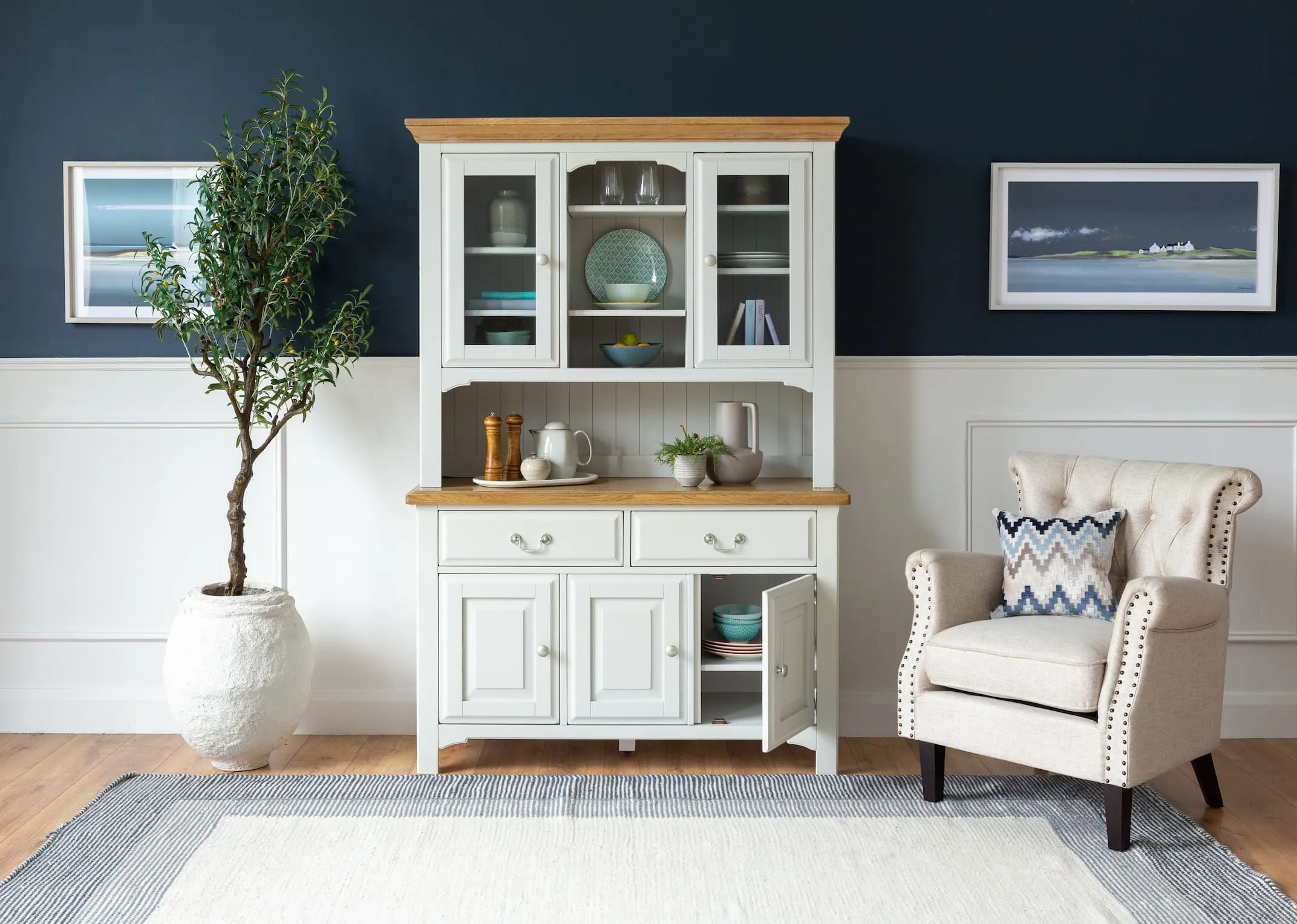 A lifestyle image of the Georgia Buffet and Hutch with Sara amrchair & a selection of accessories from EZ Living Furniture