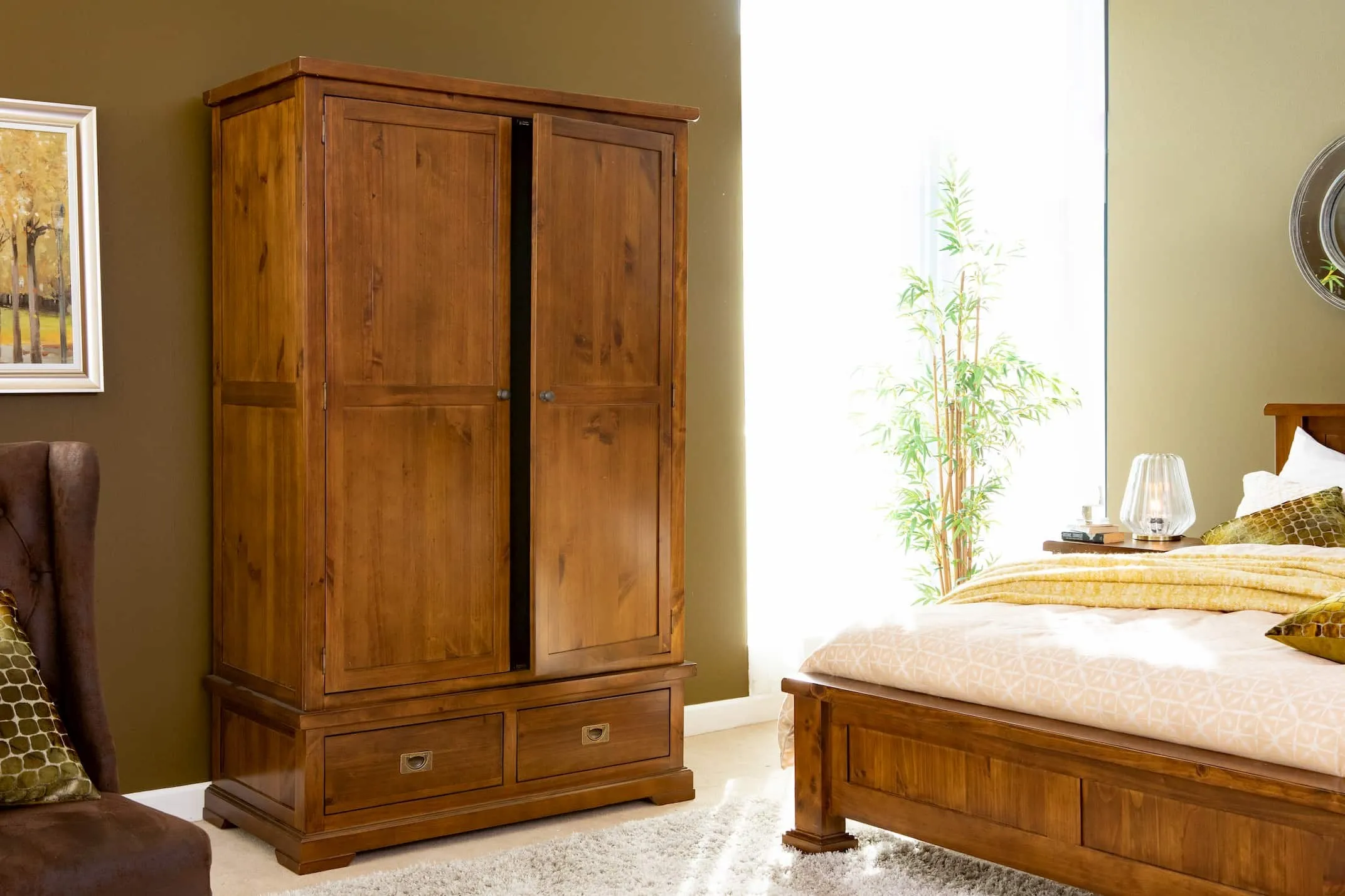 The Aisling wardrobe in dark pine in a lifestyle image with the rest of the bedroom range at EZ Living Furniture.
