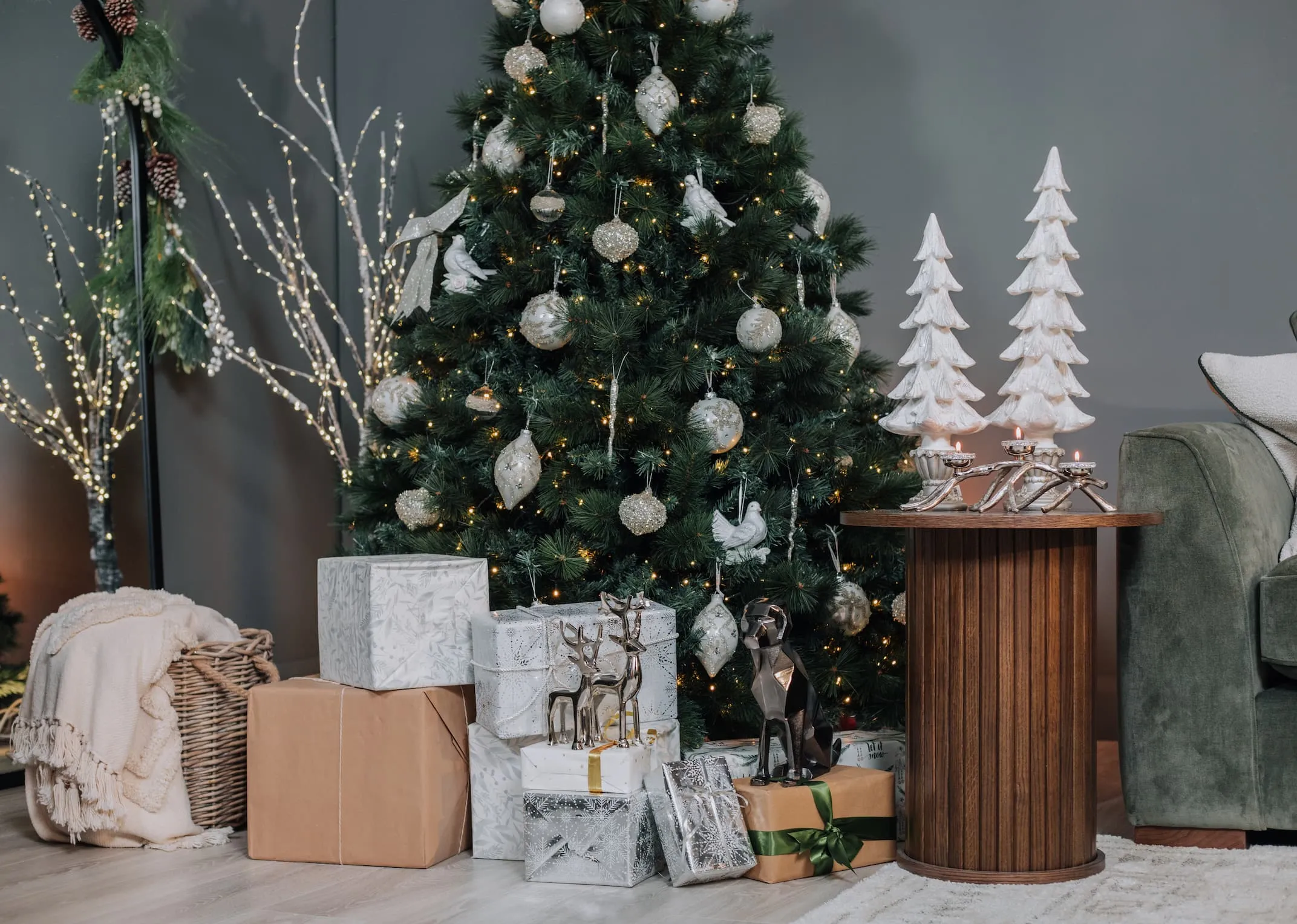 A lifestyle image of the Sherwood tree with nola side table and large & small white xmas tree ornaments