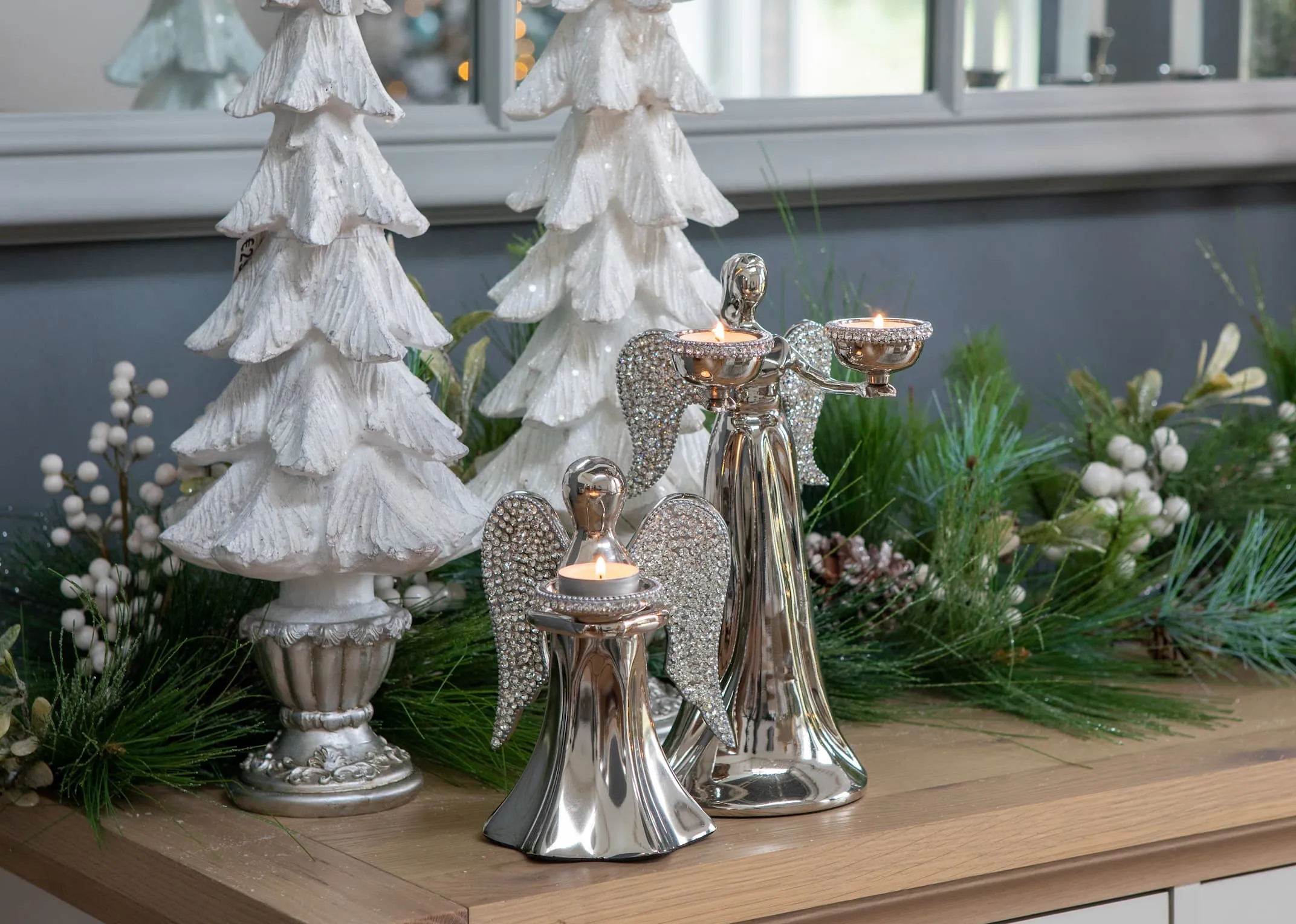 A lifestyle image of all Rhinestone Angel Candleholders with white trees & Sonoma table setting.