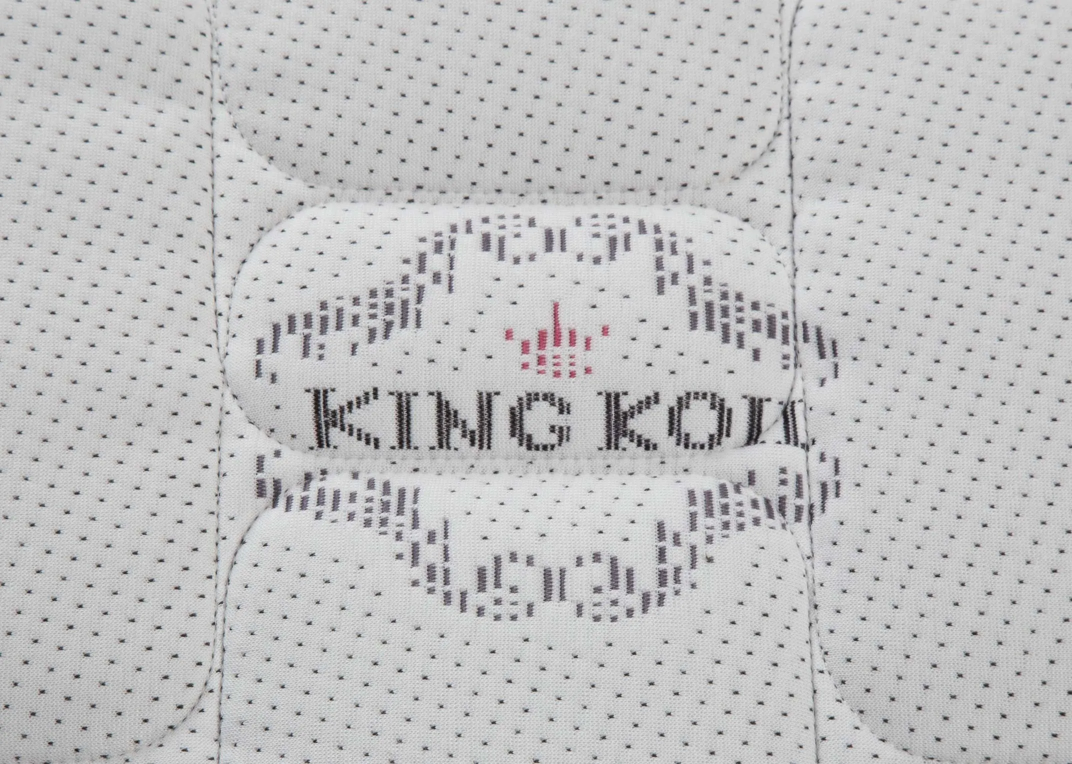 A close up of the surface on the Saol Fada Platinum 1800 Super King 6 ft beige mattress.