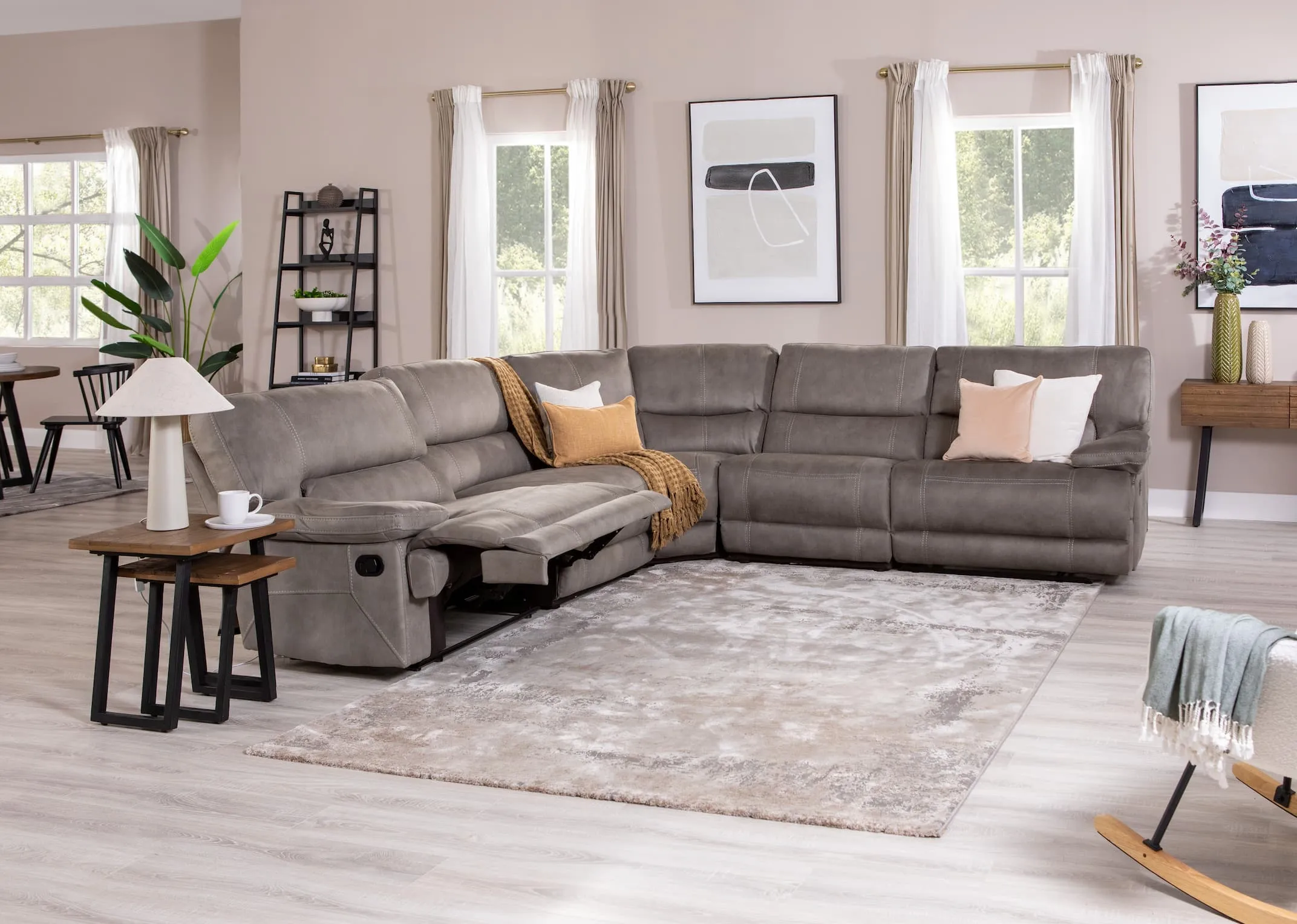 A lifestyle image of the Baxter medium corner sofa in recline mode with the range at EZ Living Furniture.