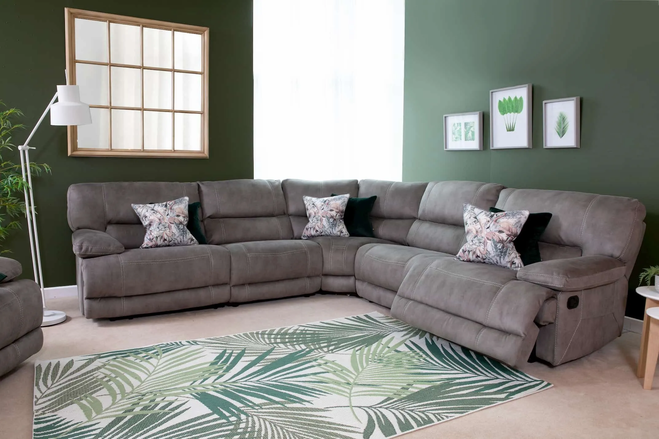 A lifestyle image of the Baxter medium corner sofa in recline mode with the range at EZ Living Furniture.