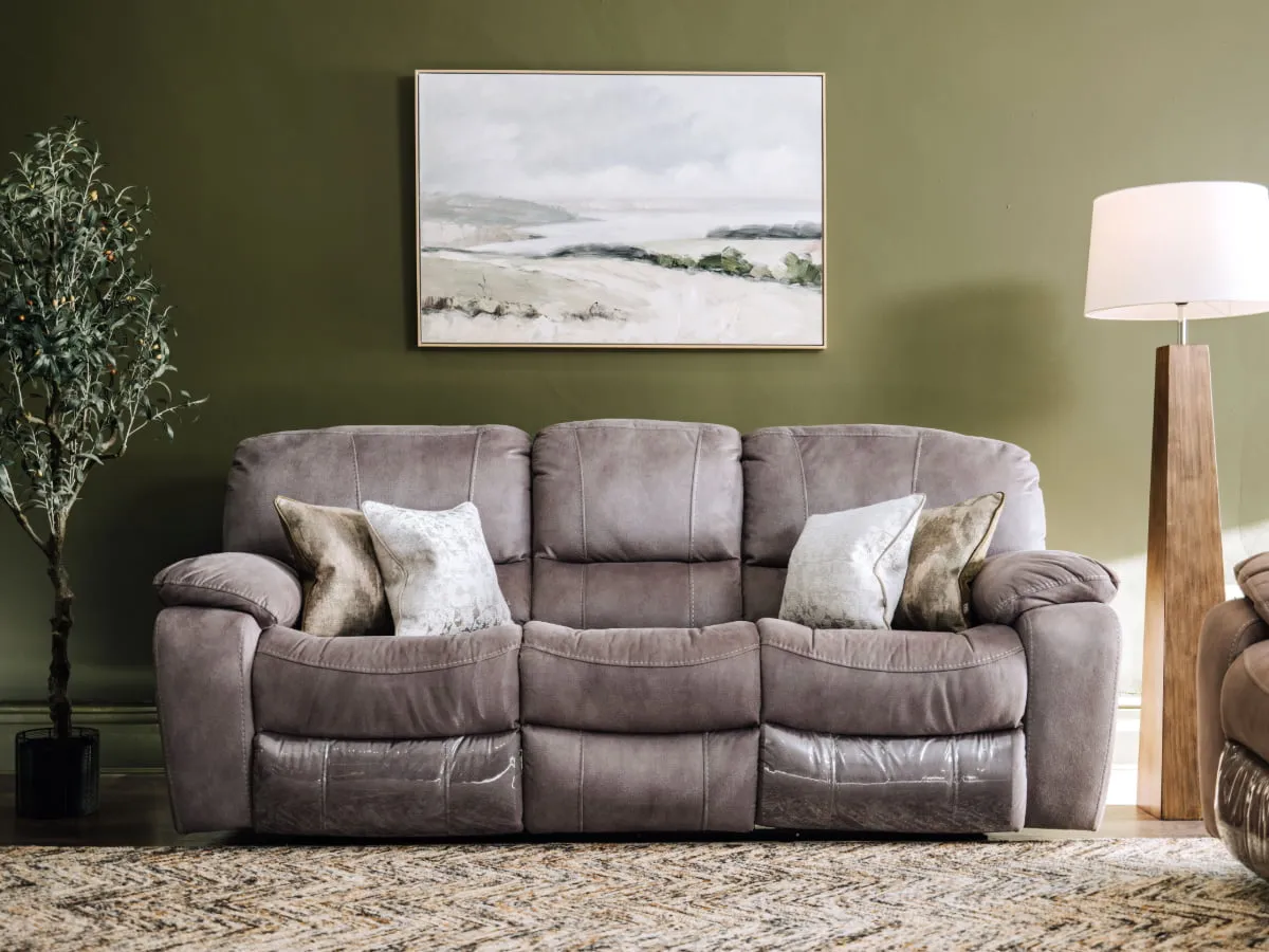 A lifestyle image of the Bradford 3 seater with Olive tree plant & Coastland canvas