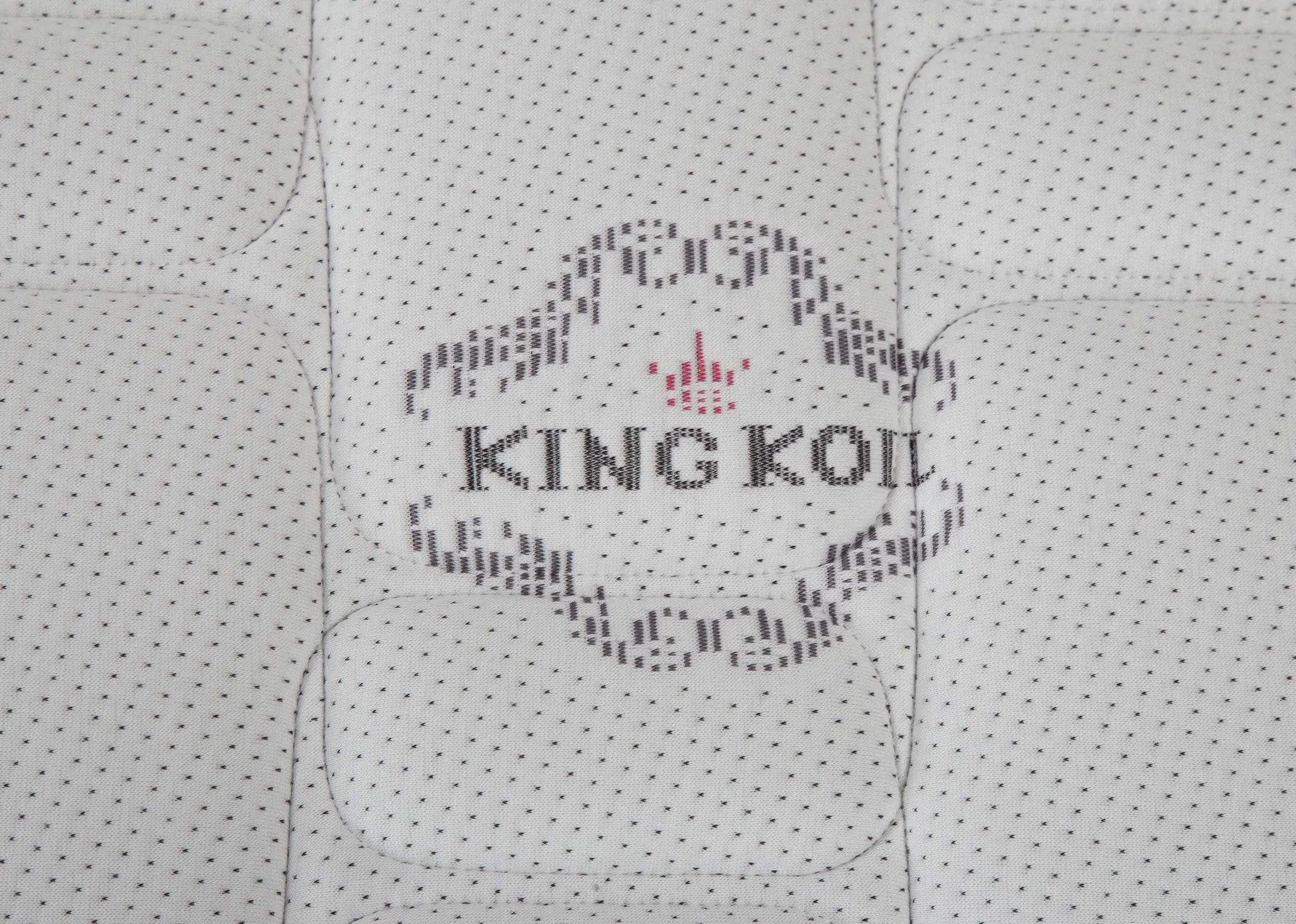 A close up of the logo and the detail on the fabric on the 4 foot 6 Posture Superb Pocket Sprung Double Mattress.