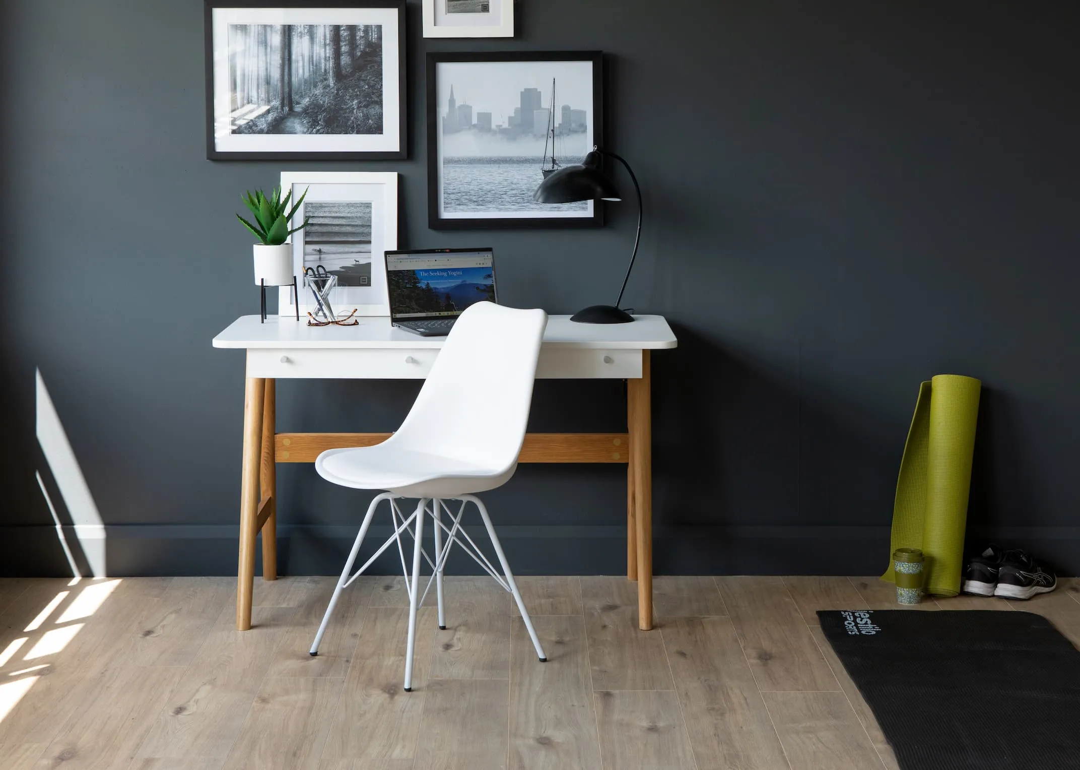 A lifestyle image of the Tia desk with Parry chair & selection of prints