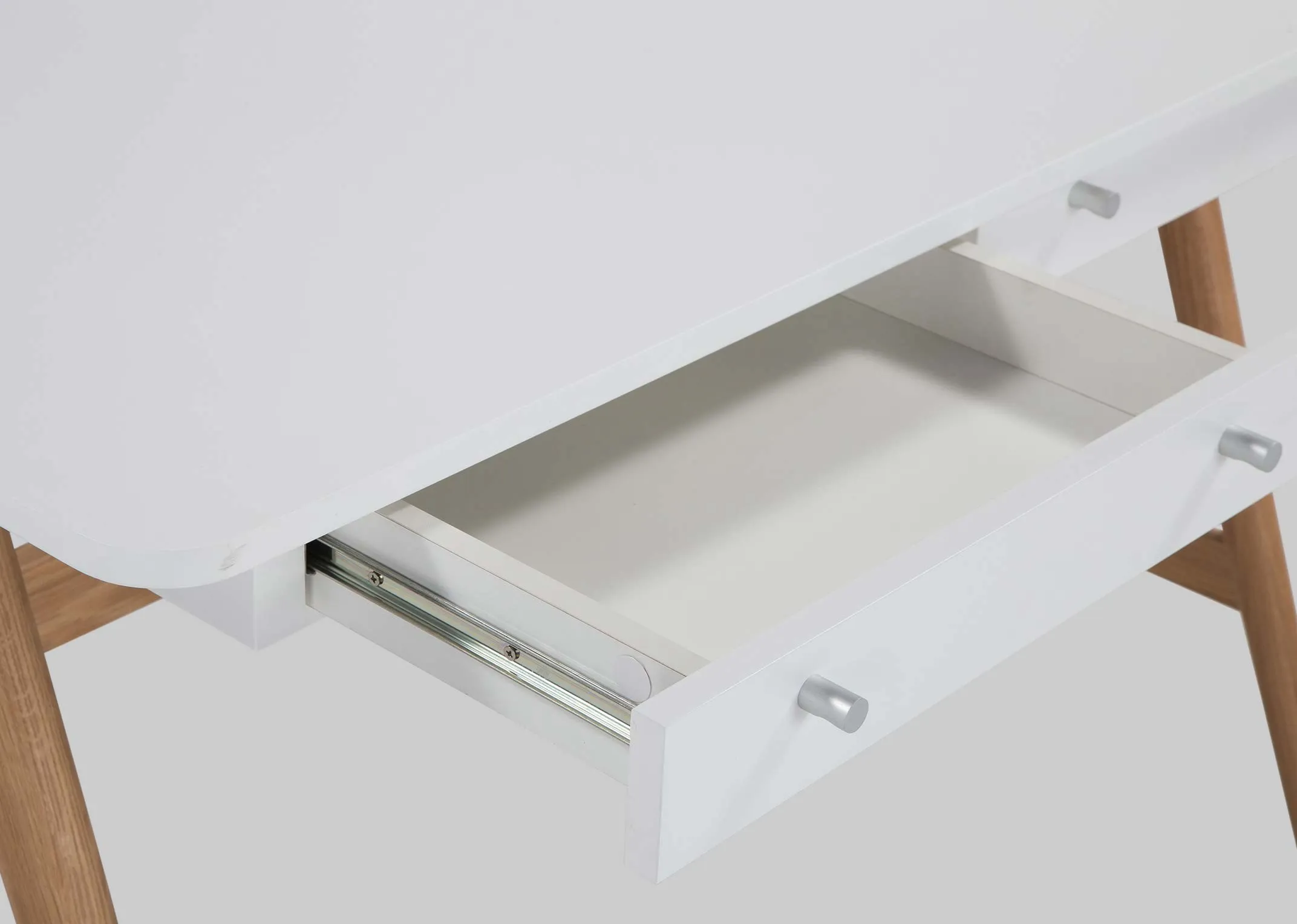 A close up view of the opened drawer on the white top Tia desk