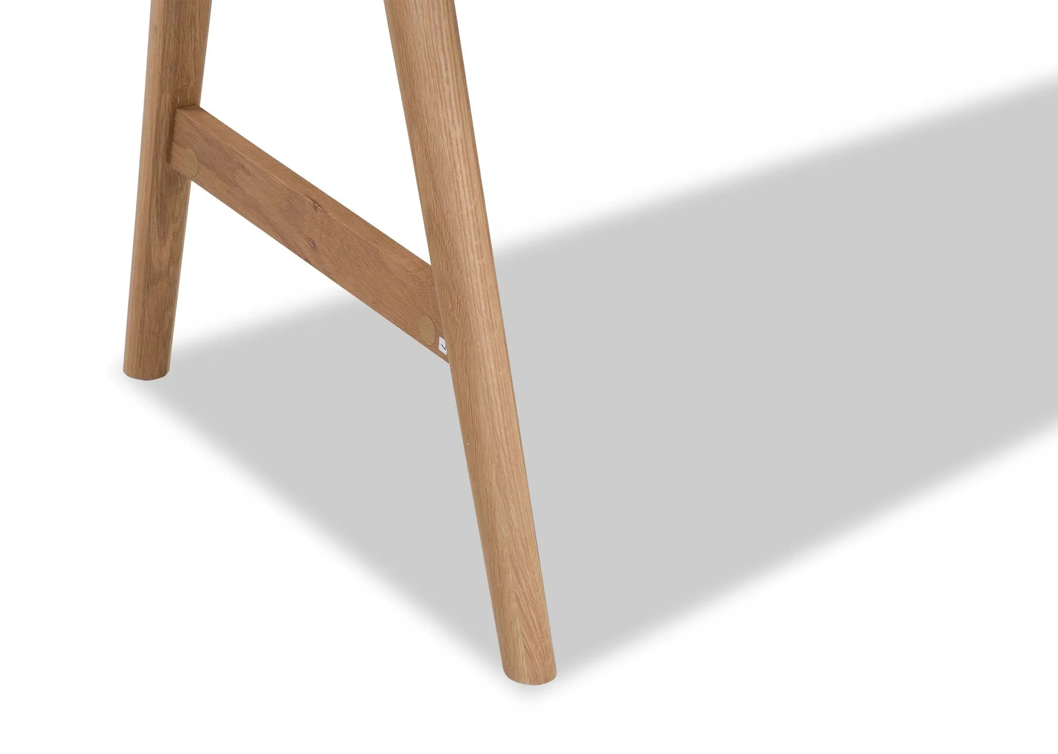 A close up of the legs on the white top Tia desk