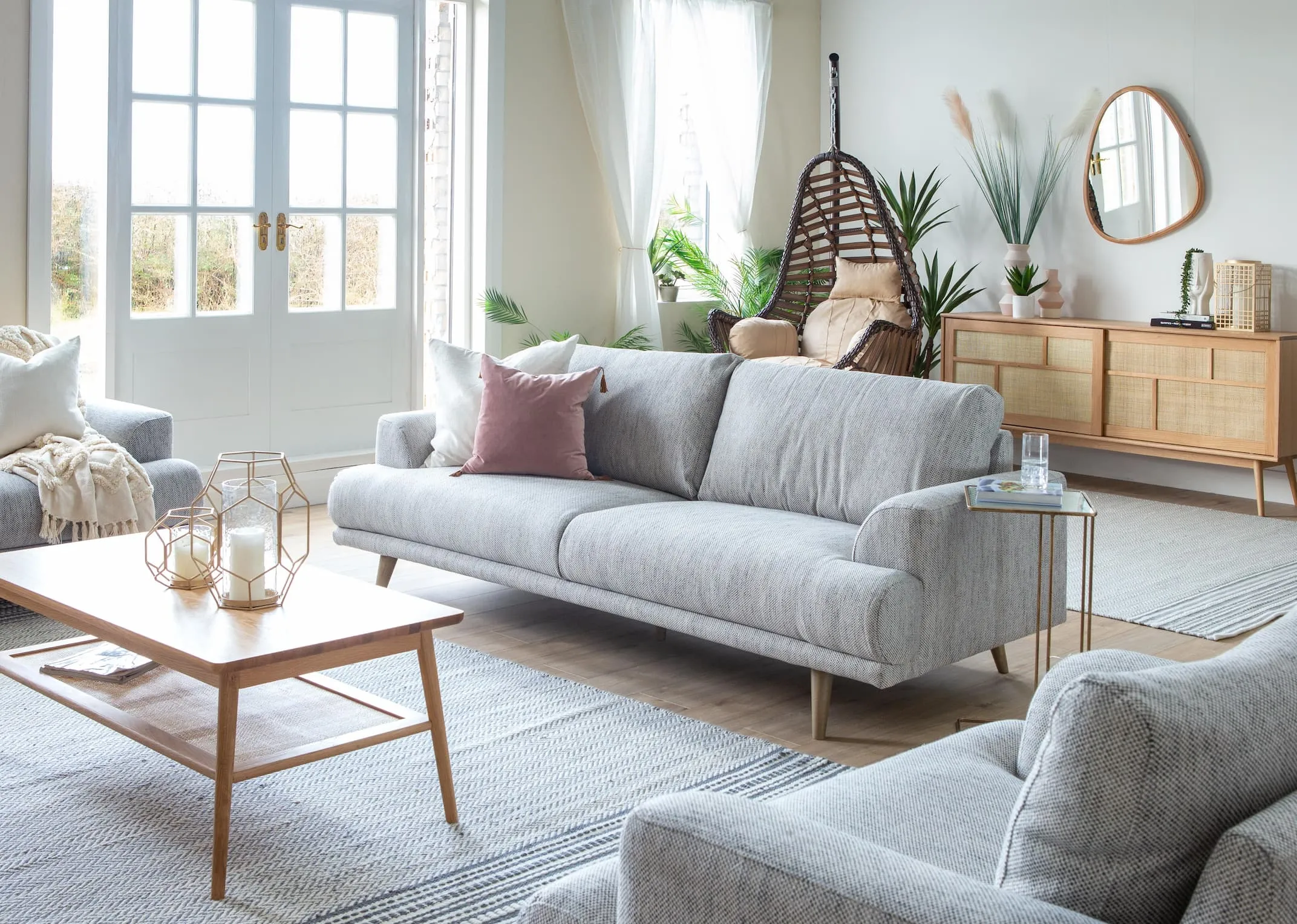 A lifestyle image of the Legend 3 Seater with barrali coffee table & sideboard with Bali egg chair.