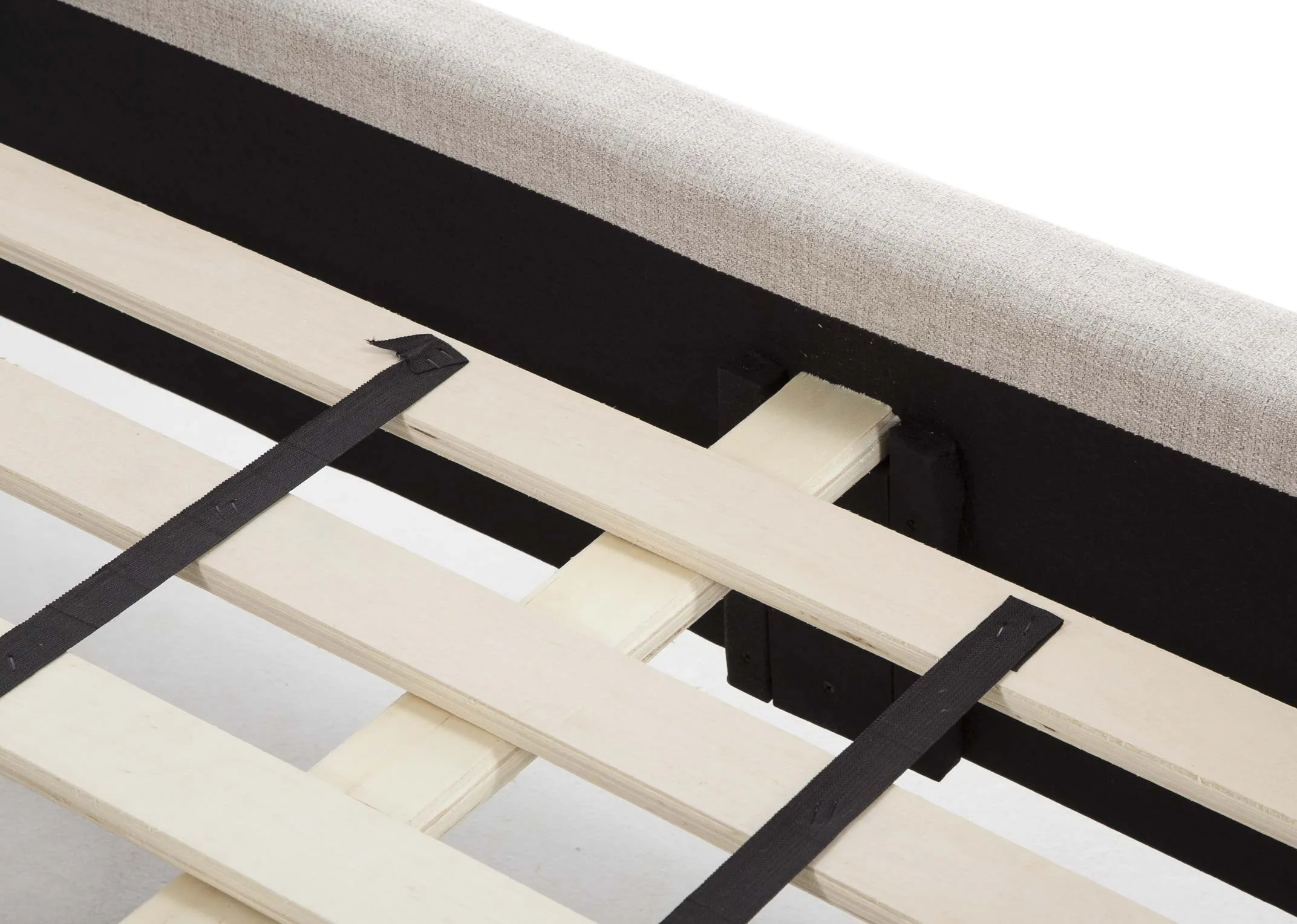 A close up view of the slats on the 5 ft beige fabric Chelsea bedframe