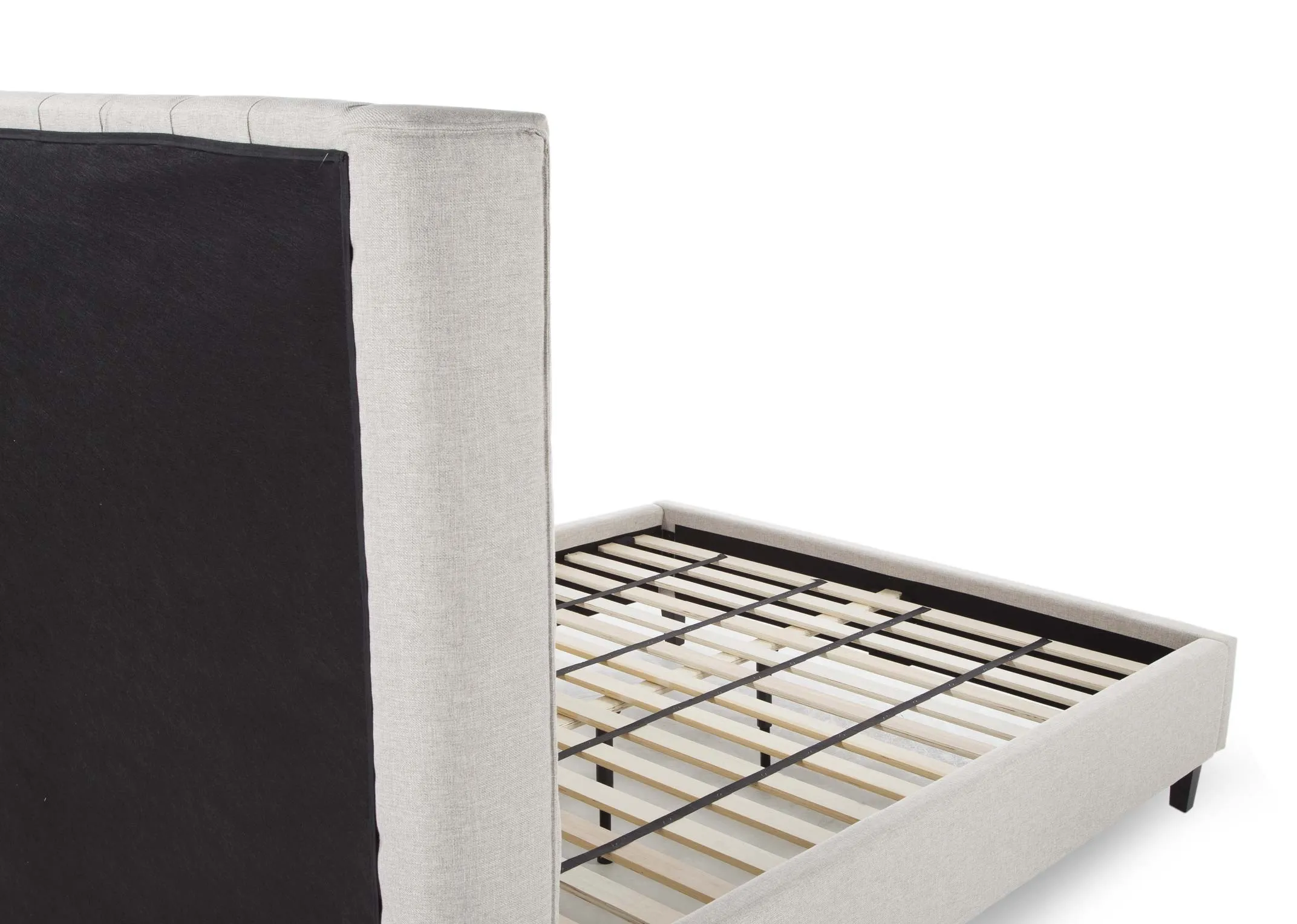 A view from behind looking at the back of the 5 ft beige fabric Chelsea bedframe