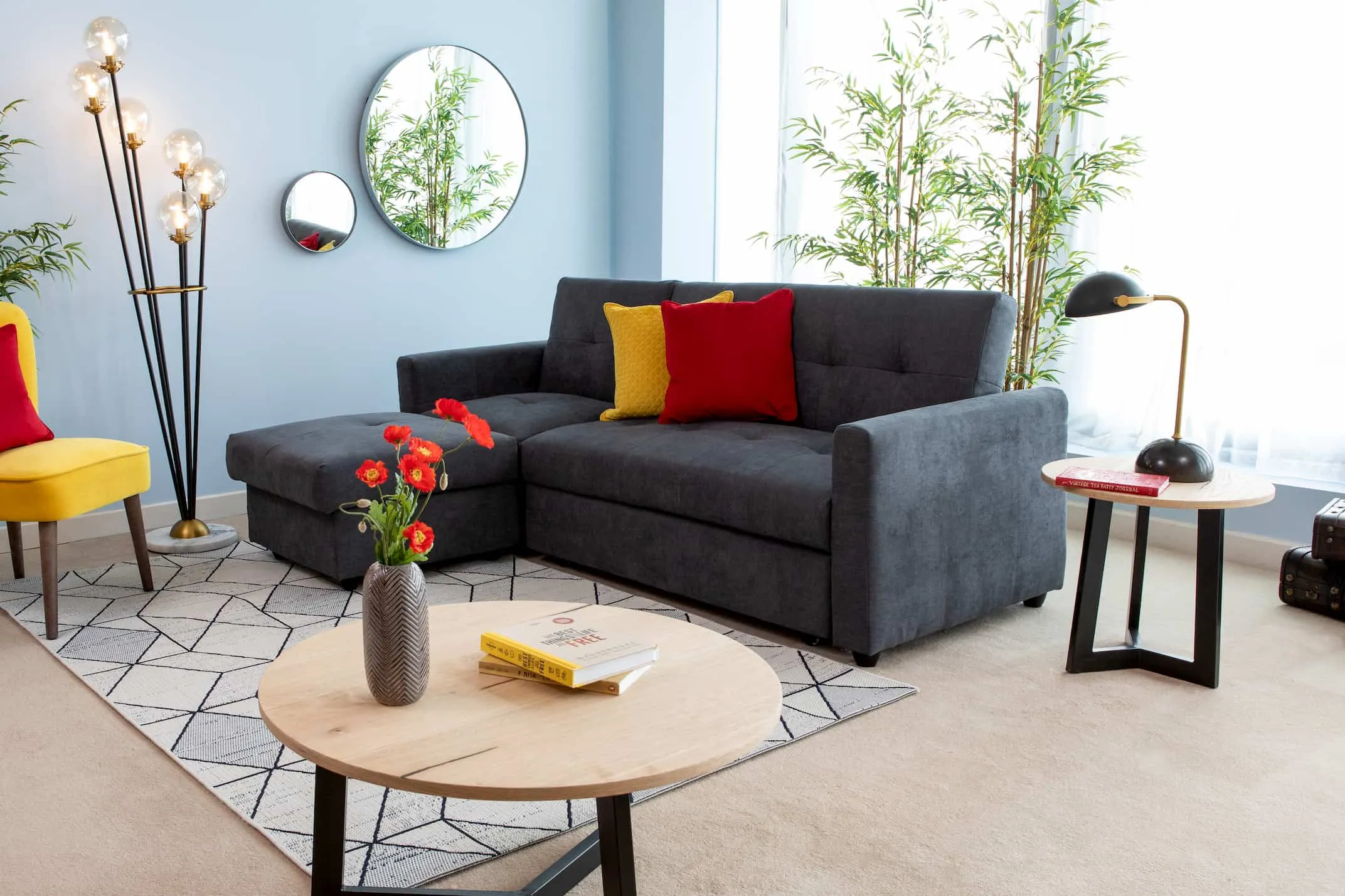 A lifestyle image of the Dalkey Sofa Bed with Ortez Foor lamp & Naomi furniture