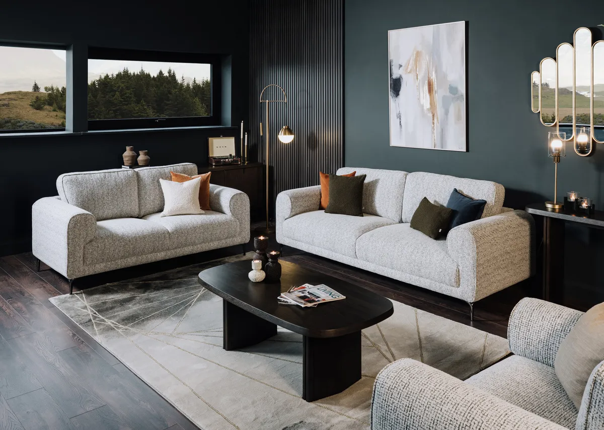 A lifetsyle image of the Avery rug with the Oyster sofas and flow furniture.
