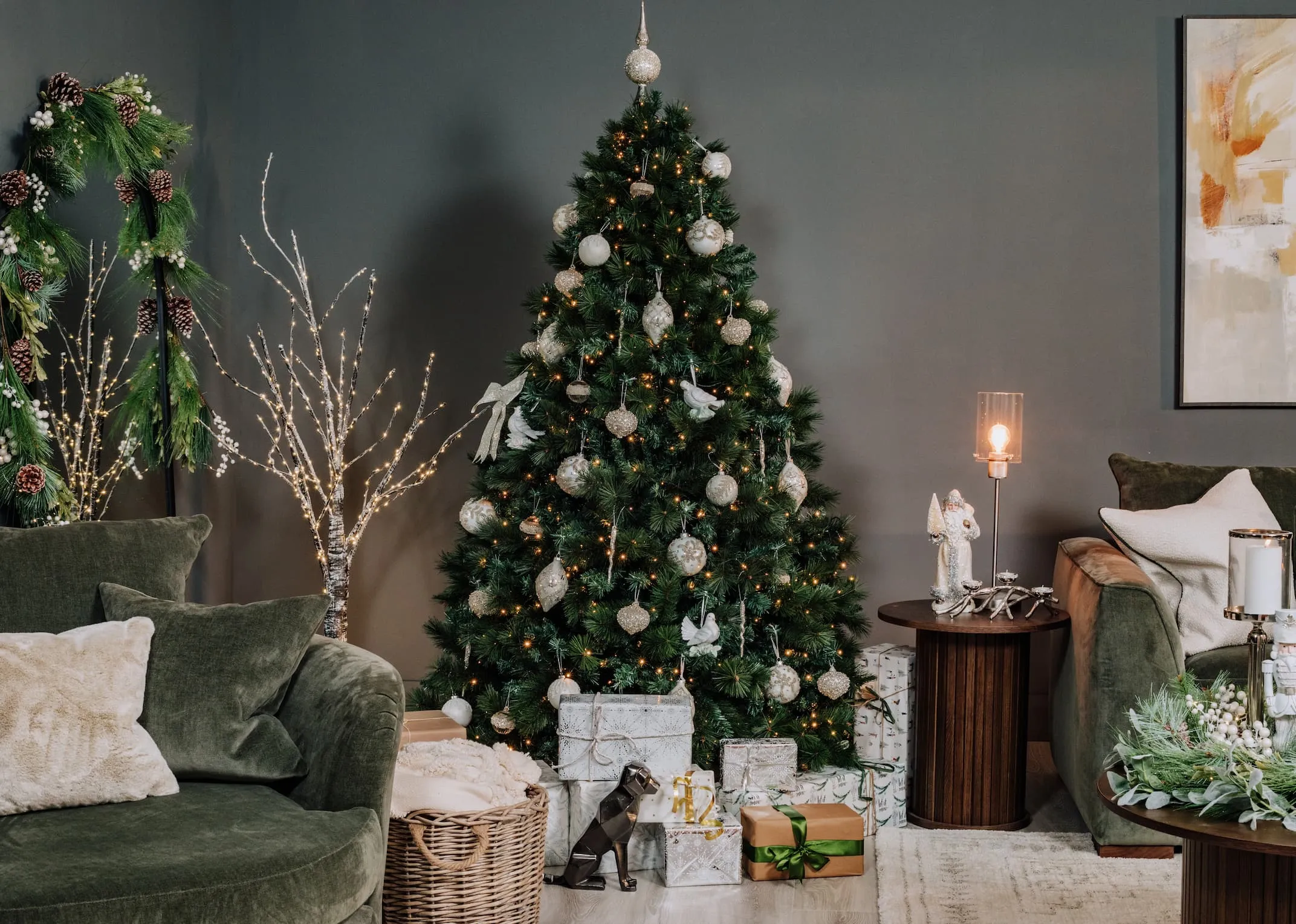 A lifestyle image of the Sherwood tree with birch tree to the left and Nola table with Glitter Santa.