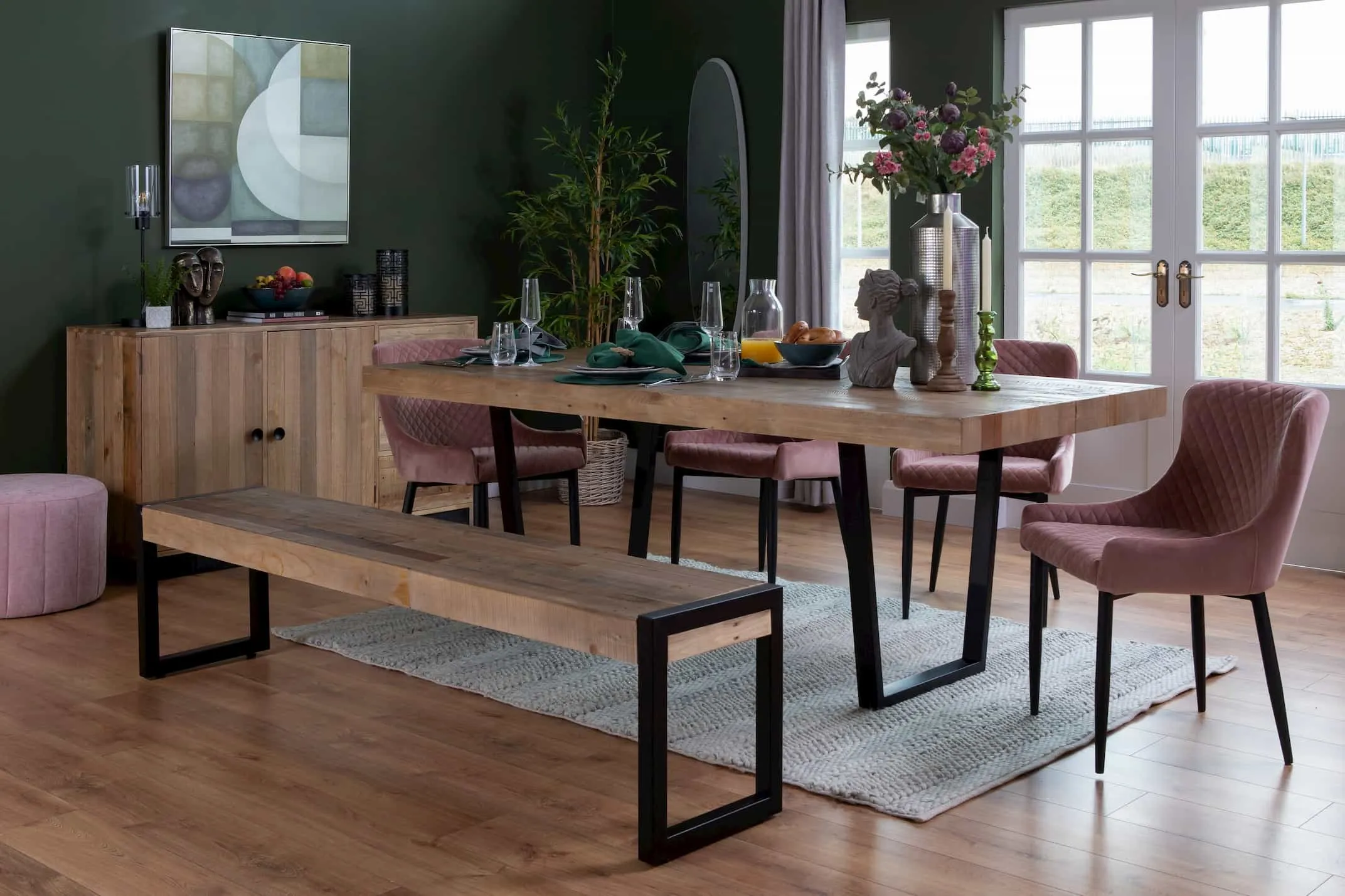 A lifestyle image of the Darian Mirror with the San Francisco Dining Table with Ottowa Chairs & Alexo Pouffe.