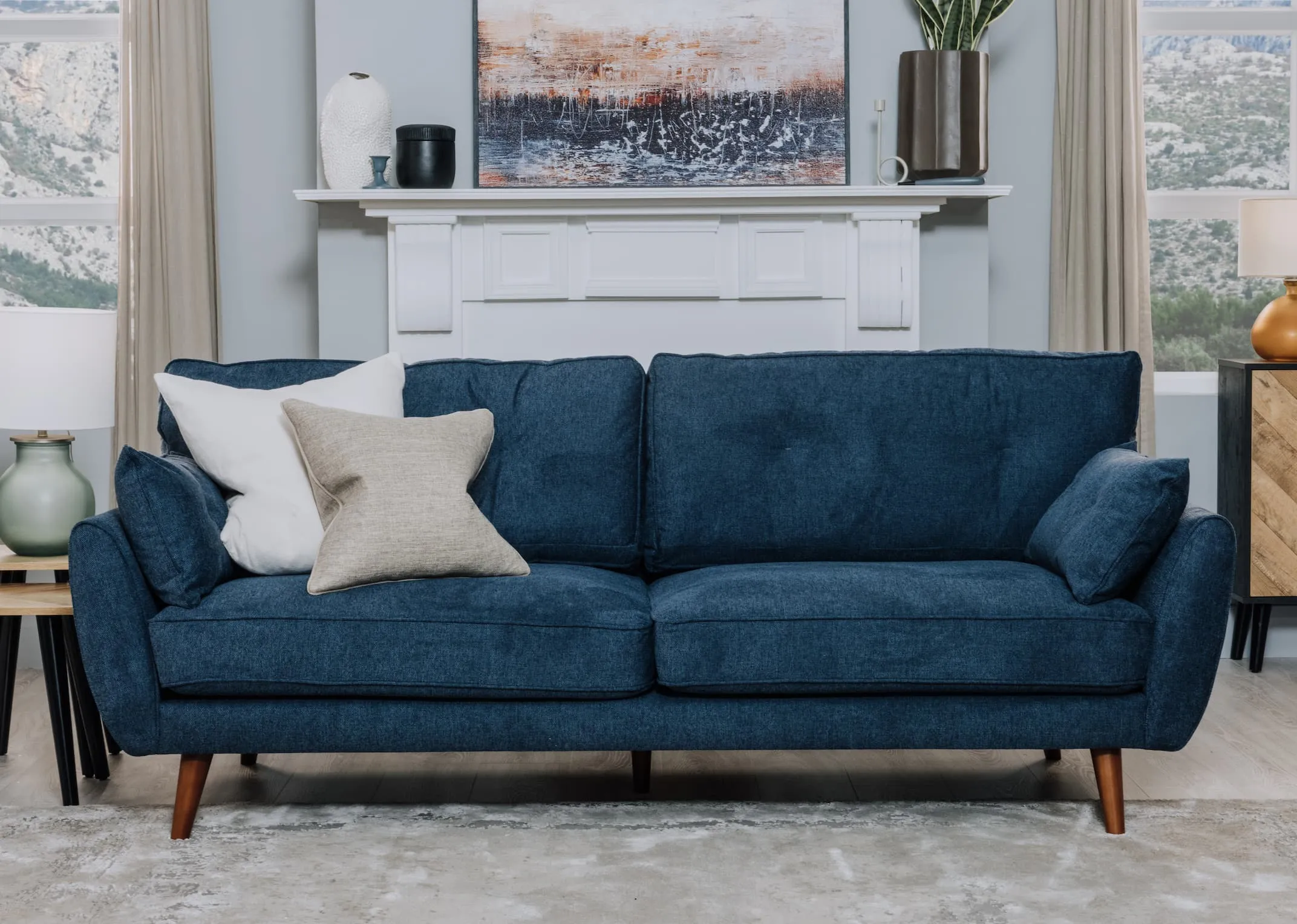 A lifestyle image of the Caoimhe 3 Seater with Wicklow nest of tables.