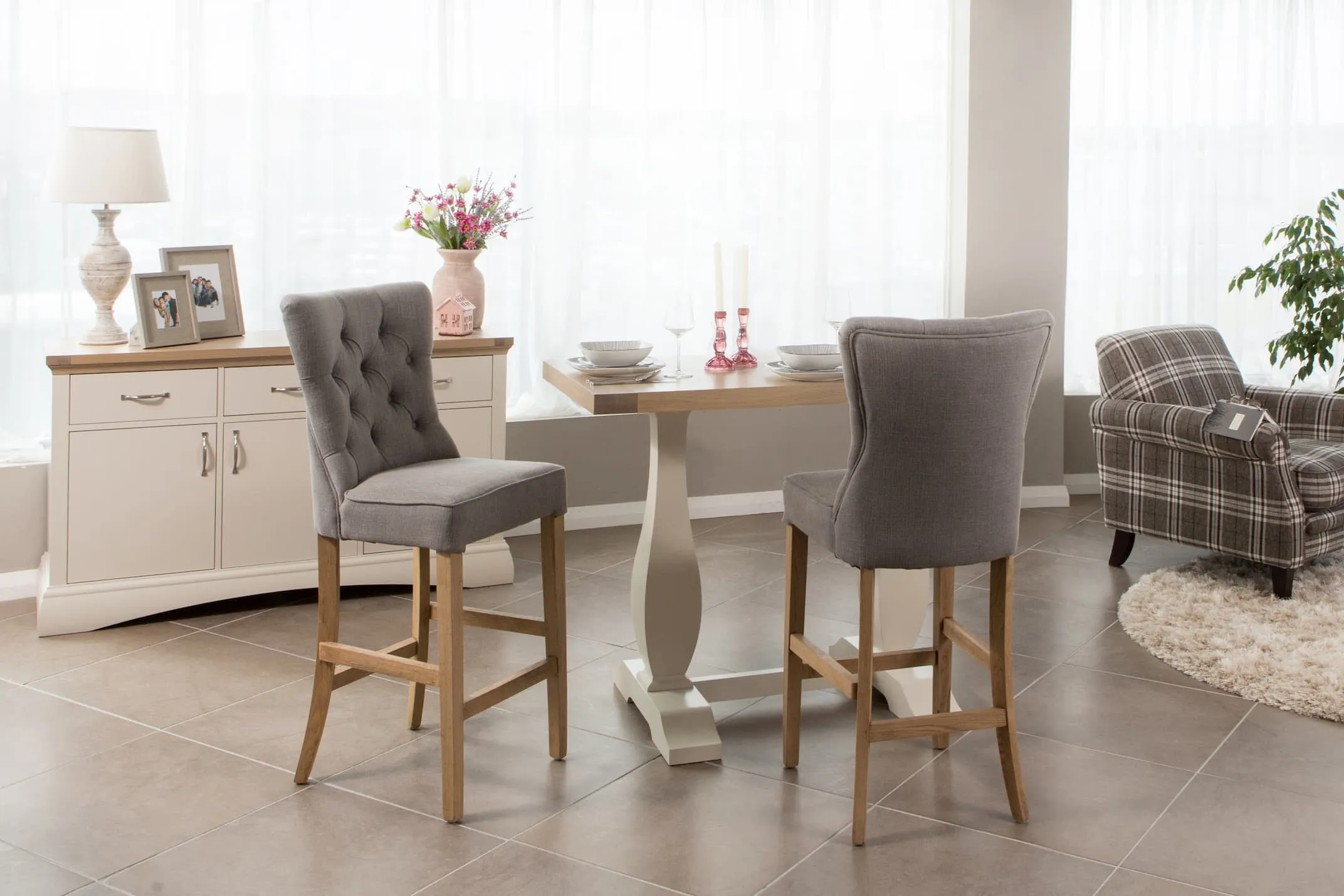 A lifestyle image of the Clara Grey Fabric Bar stool similar to the Counter stool with Sonoma Bar Table.