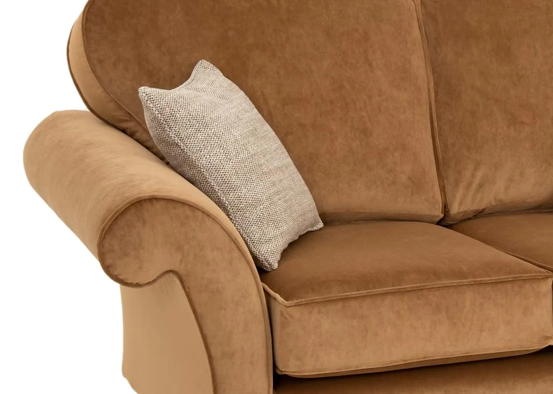 A 2 seater gold velvet sofa from EZ Livings Lauren range. Closeup of piping trim around armrest.