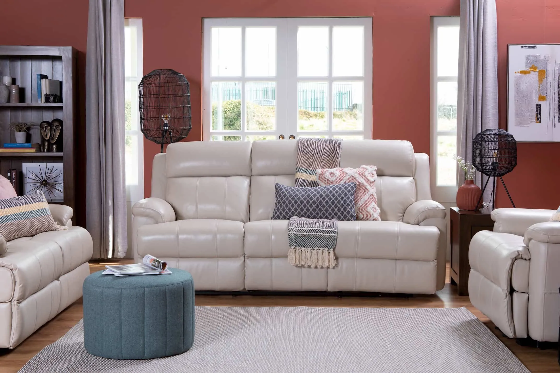 A lifestyle image of the 3 Seater Embrace White leather sofa with the matching chair & 2 seater & Montreal Furniture.