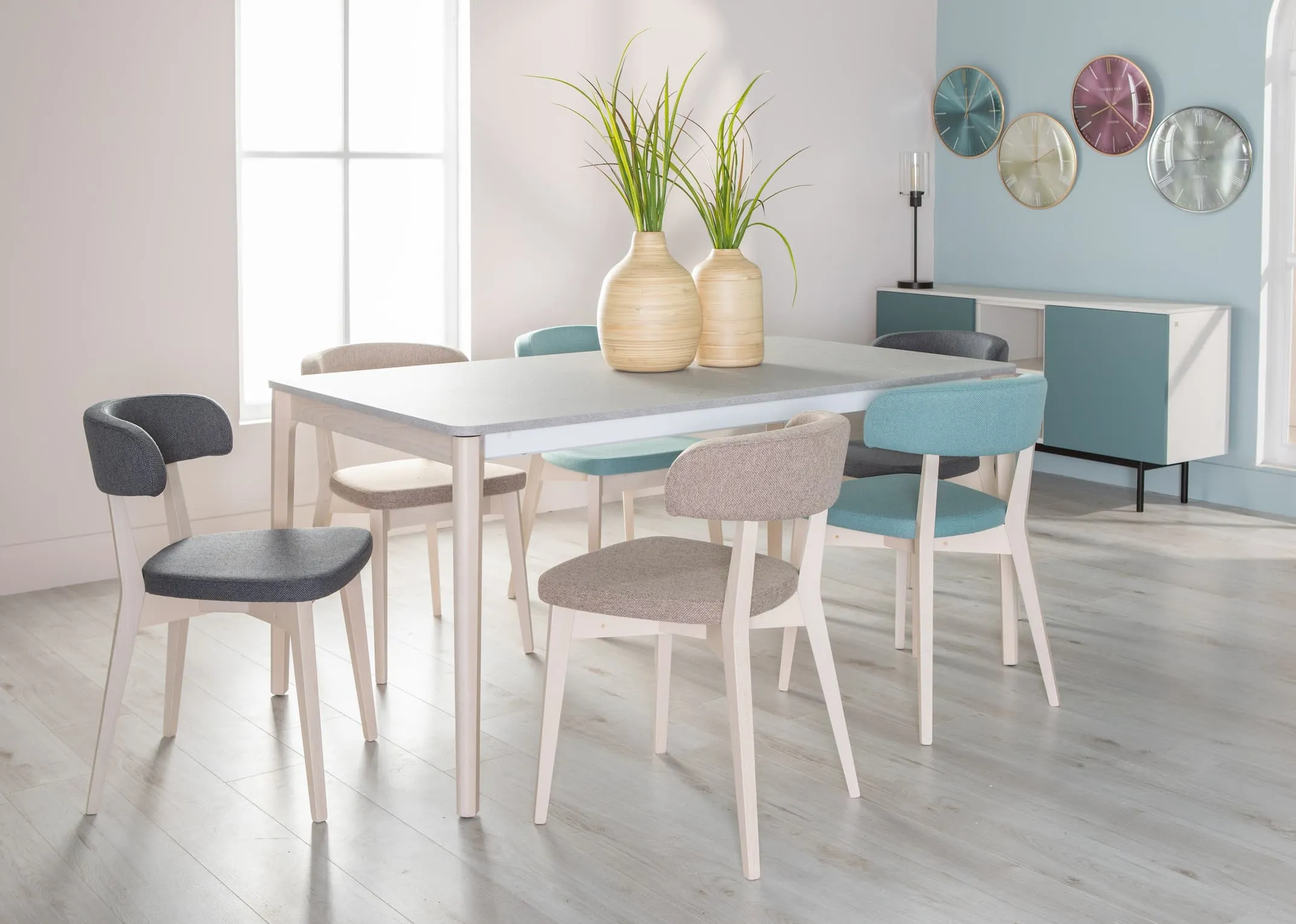 A lifestyle image of the Tabla Dining Table with oyster clocks