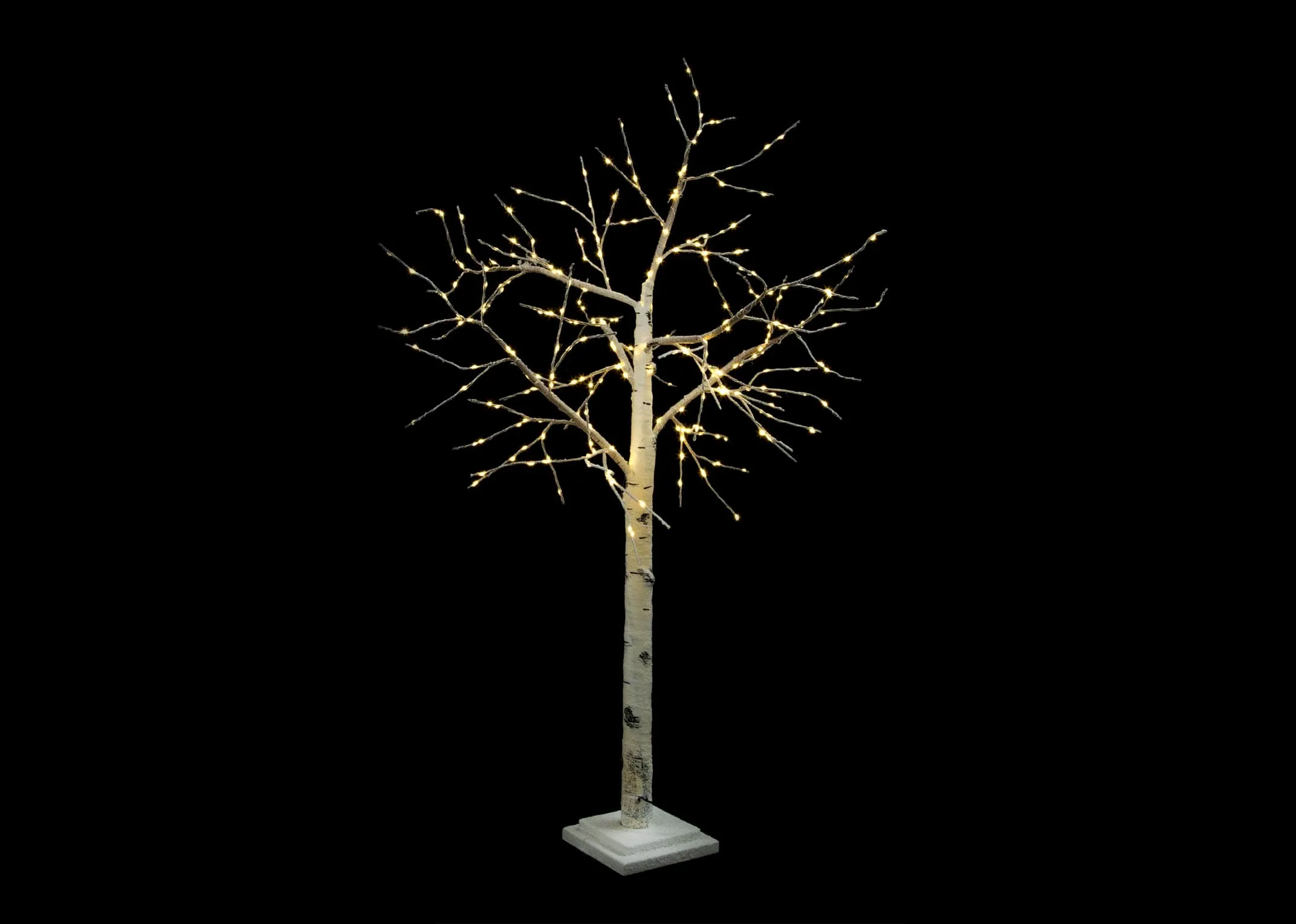 A small birch decorative tree on stand with 300 led lights from EZ Living Furnitures Christmas range. Lights on in darkness