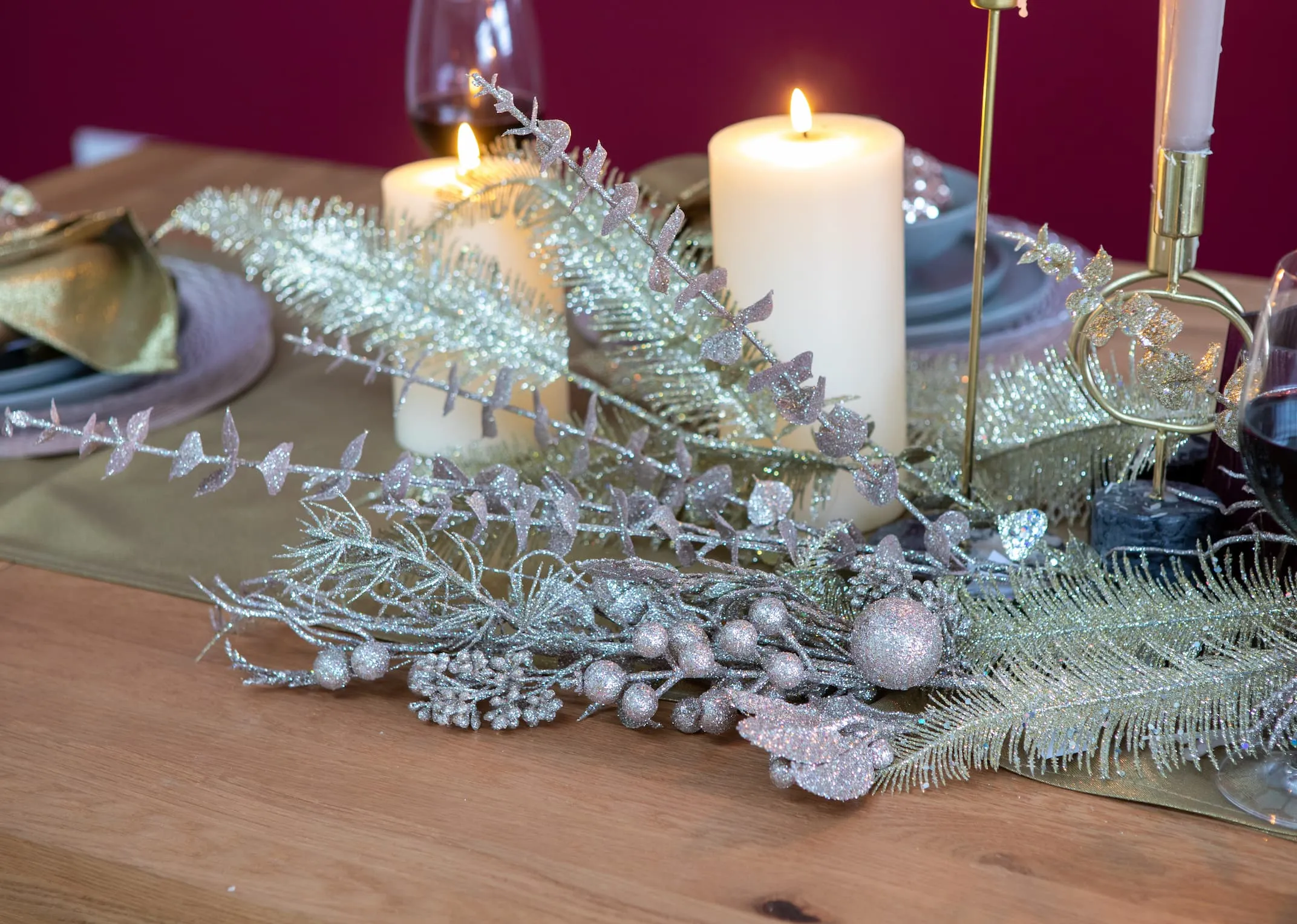 A lifestyle image of the Pink eucalyptus pick with candles