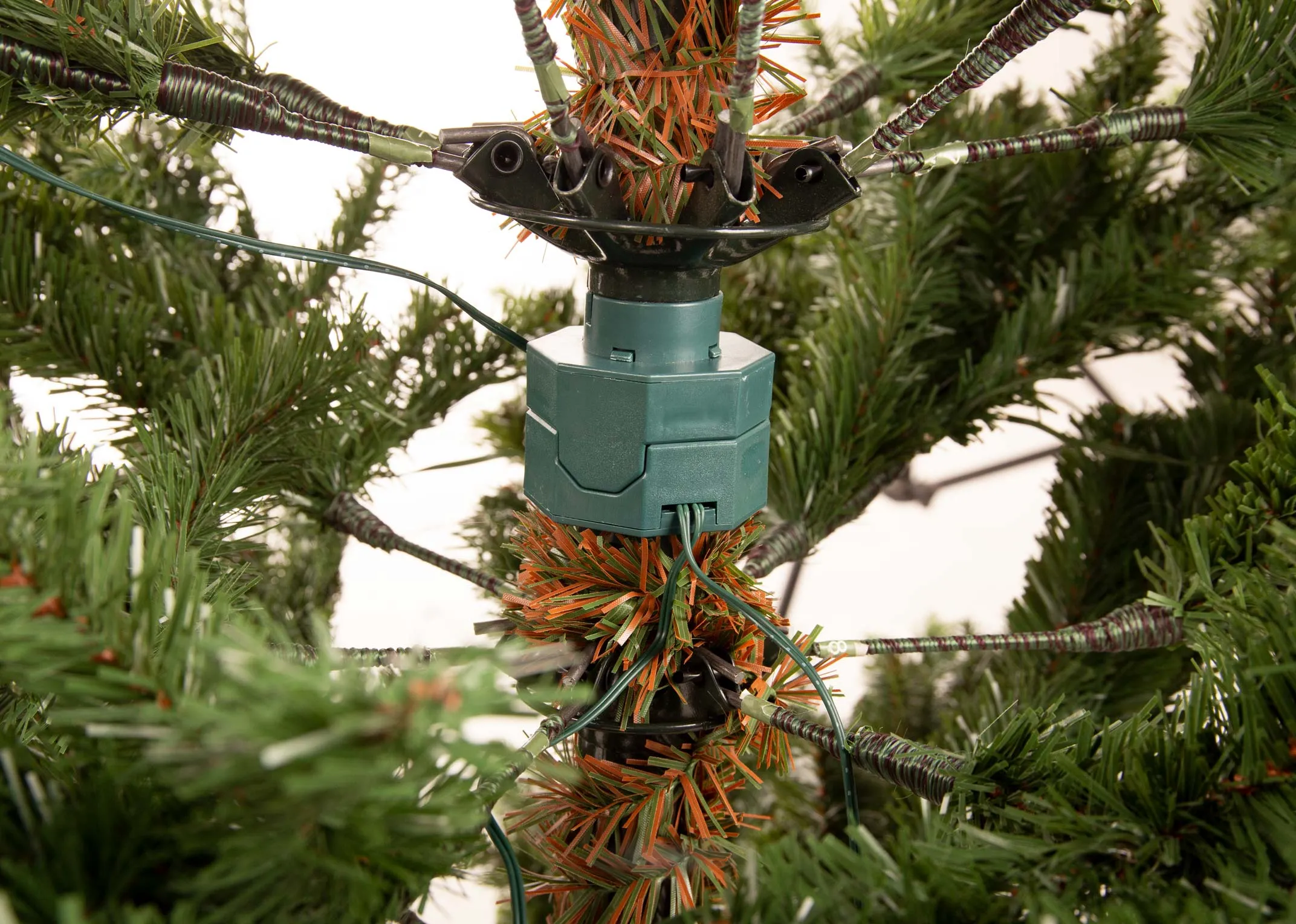 An 8ft green Christmas tree on a stand from EZ Living Furniture's Rockefeller range. Closeup of the tree part now attached