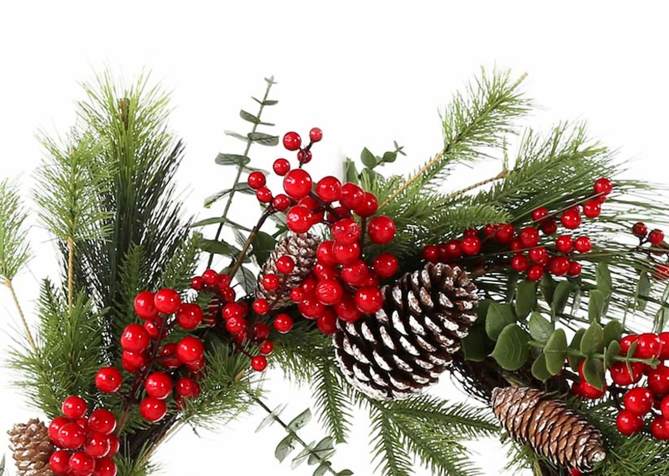 A pine wreath with berries & snowy pine cones from EZ Living Furniture's Christmas Range. Closeup of berries & pine cones