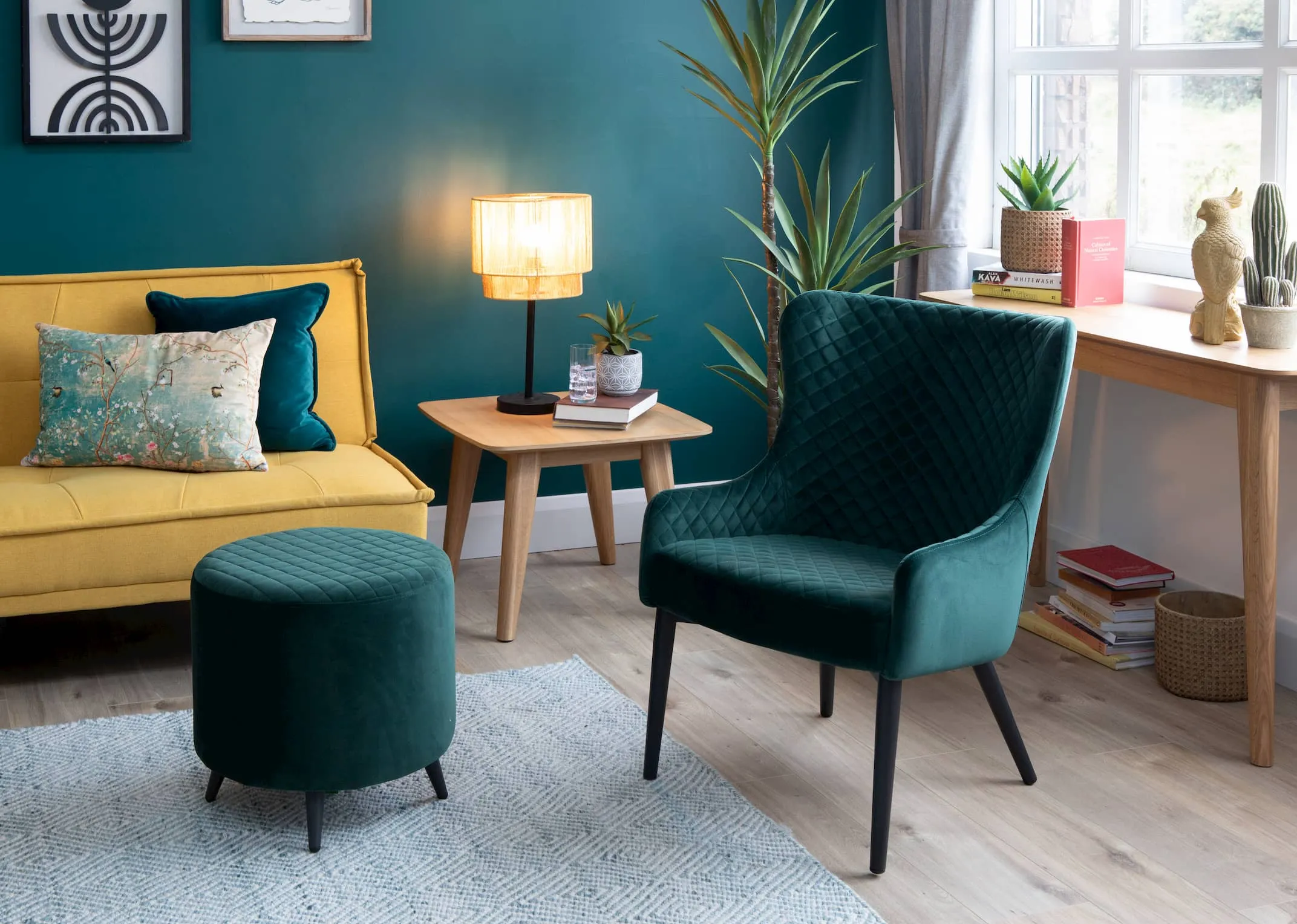 A lifestyle image of the matching Ottowa Green Lounge Chair & footstool with Seattle Yellow Sofa bed & Rho furniture.