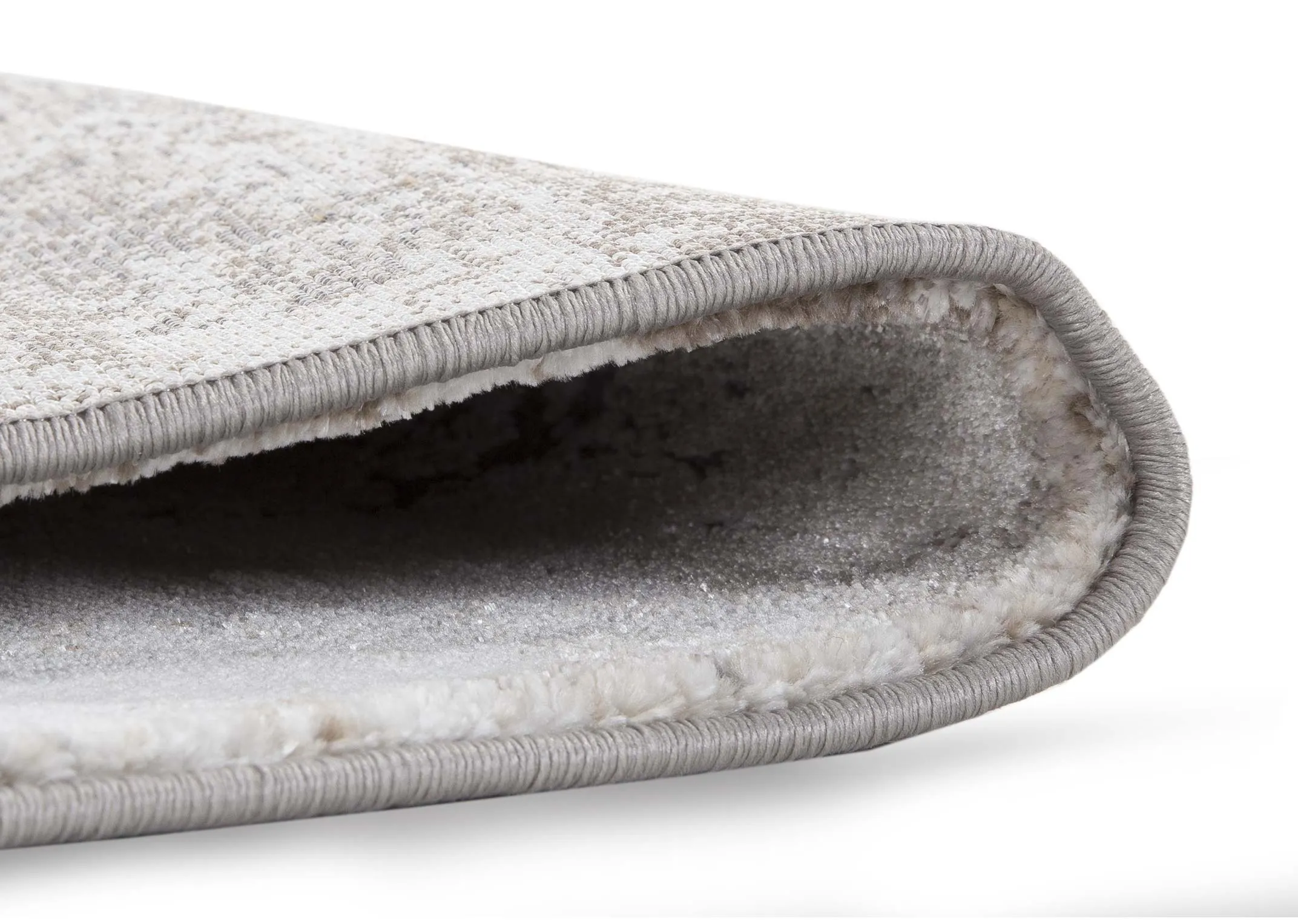 A grey ombre rug in Small from EZ Living Furniture's Kylo range. View of rug folded to show pile