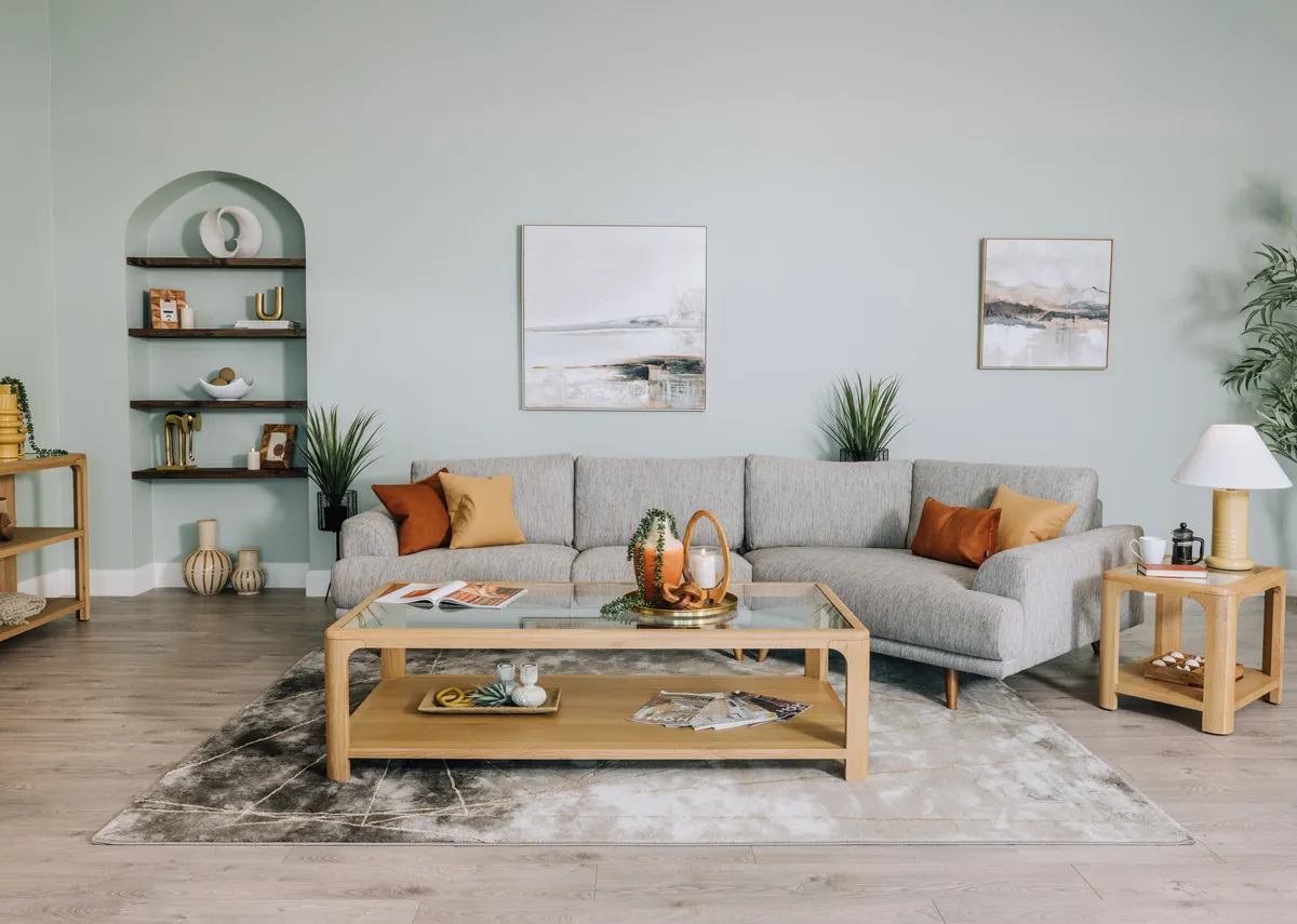 A lifestyle image of the Legend corner sofa with gus coffee table and lamp table with avery rug.