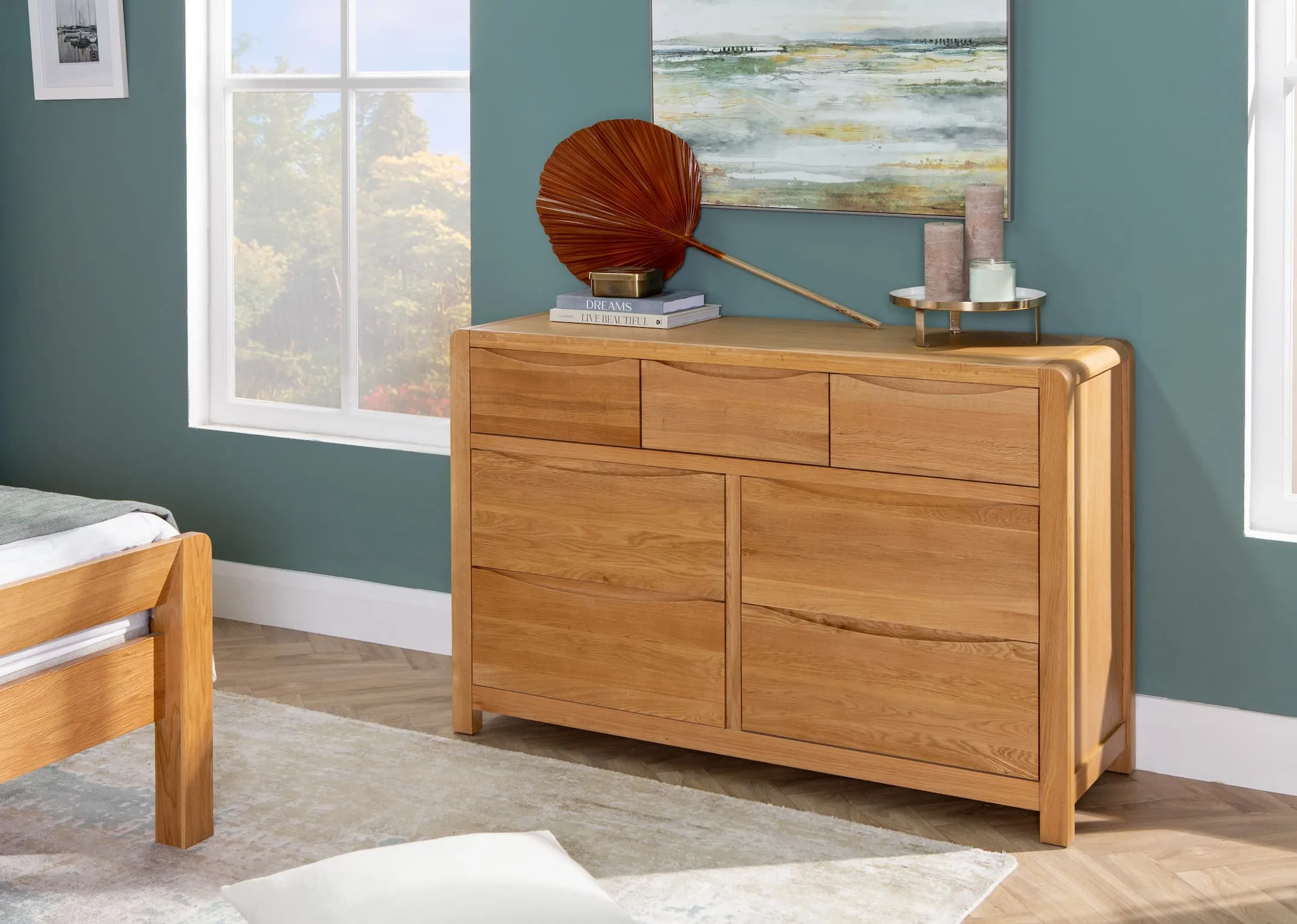 A lifestyle image of the iris Chest of 7 drawers with the matching bedframe & Plantae fan