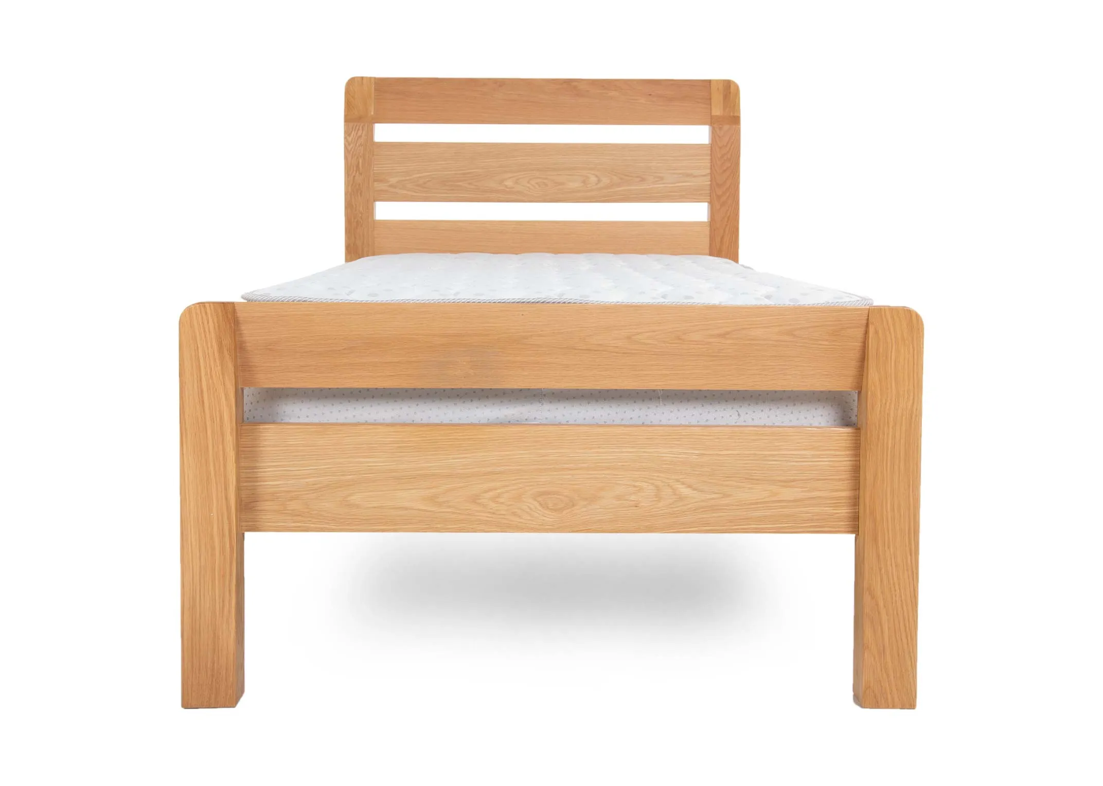 An oak 3ft single bedframe from EZ Livings Iris range. Front view of double slat footboard & high ladder headboard