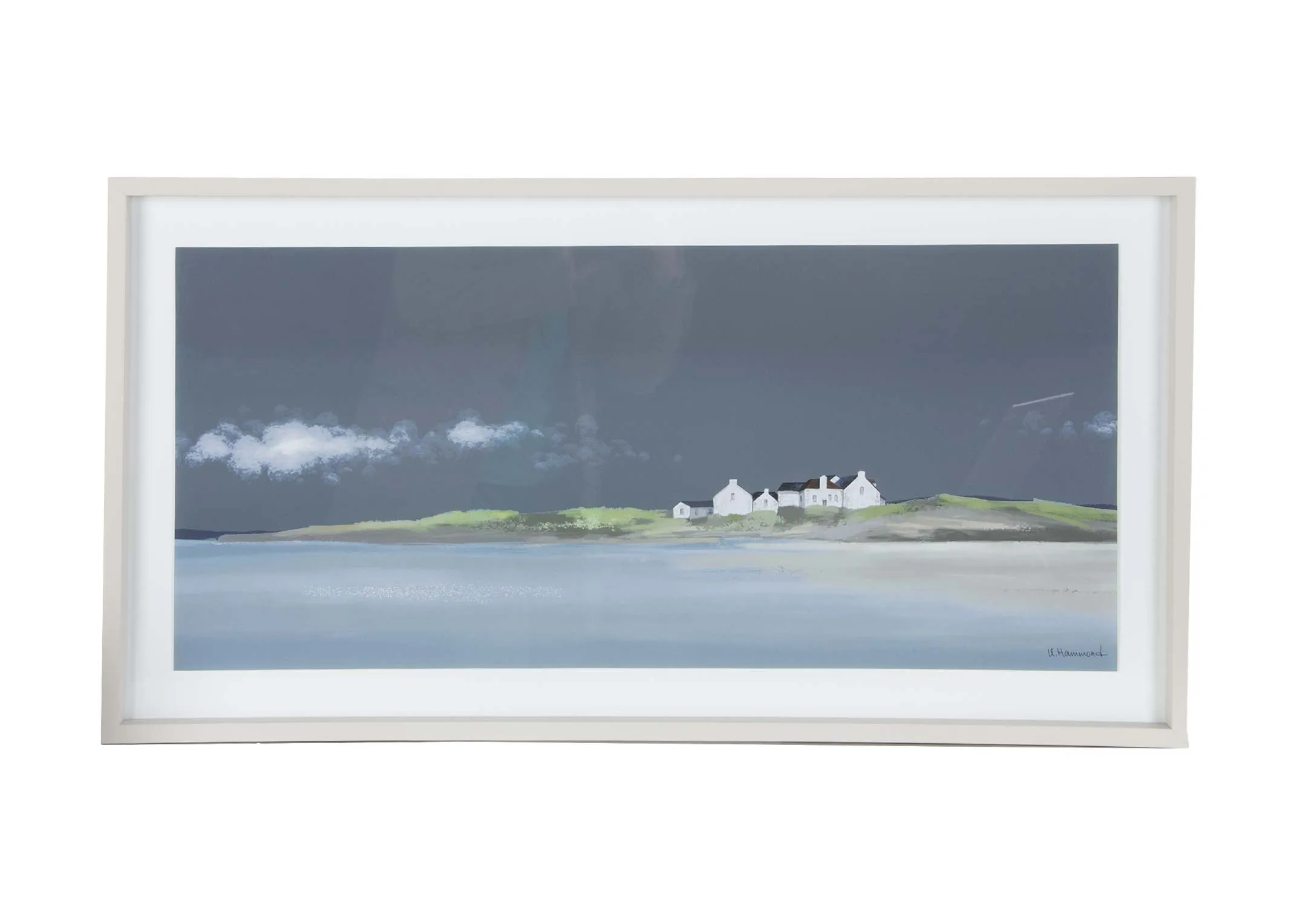 A white framed print of a house on the coast from Ulyana Hammond. Front view of coastal scene.