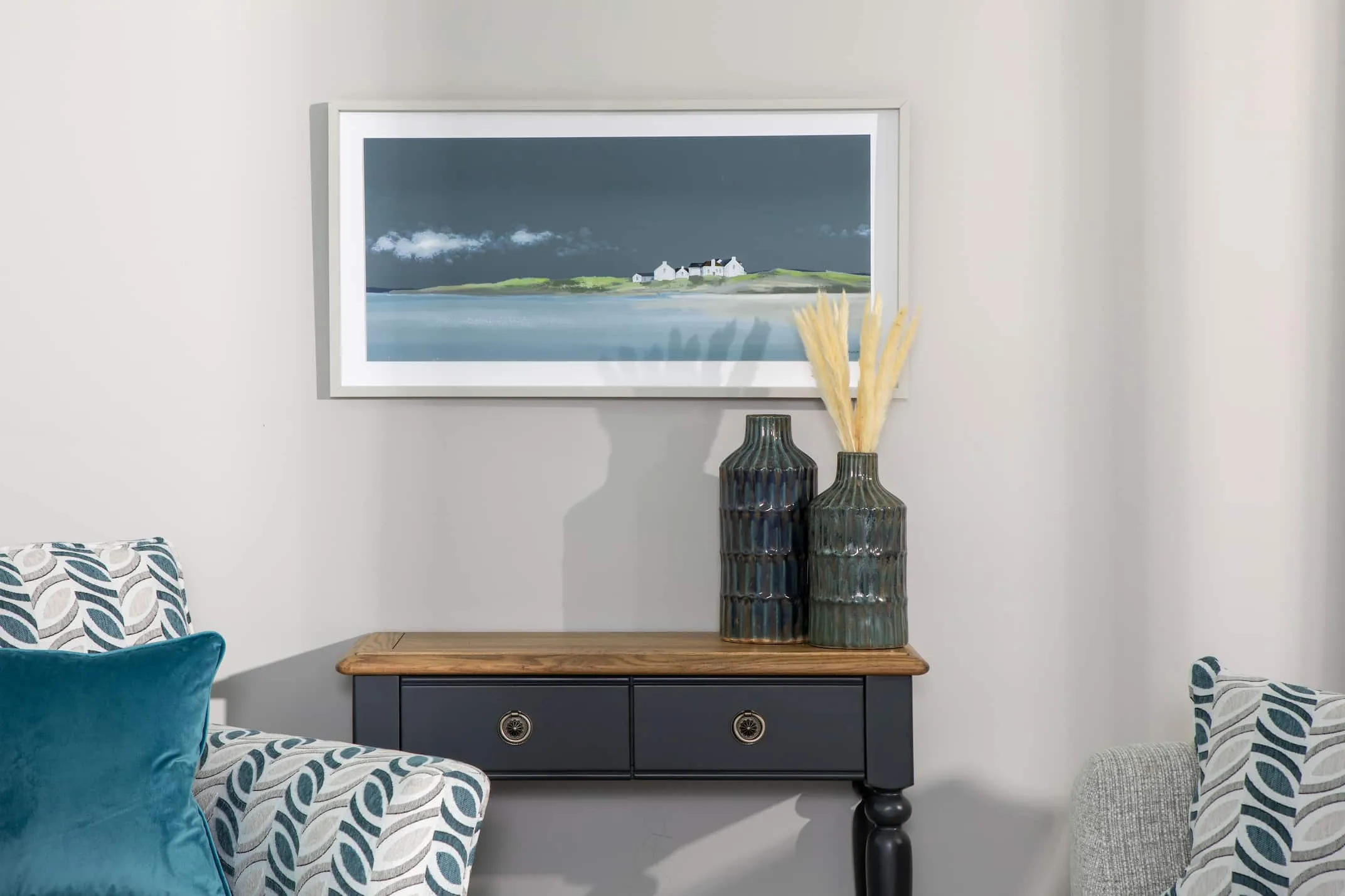 A lifestyle image of Ulyana Hammond's True Blue print over the Toulouse Console Table from EZ Living Furniture.