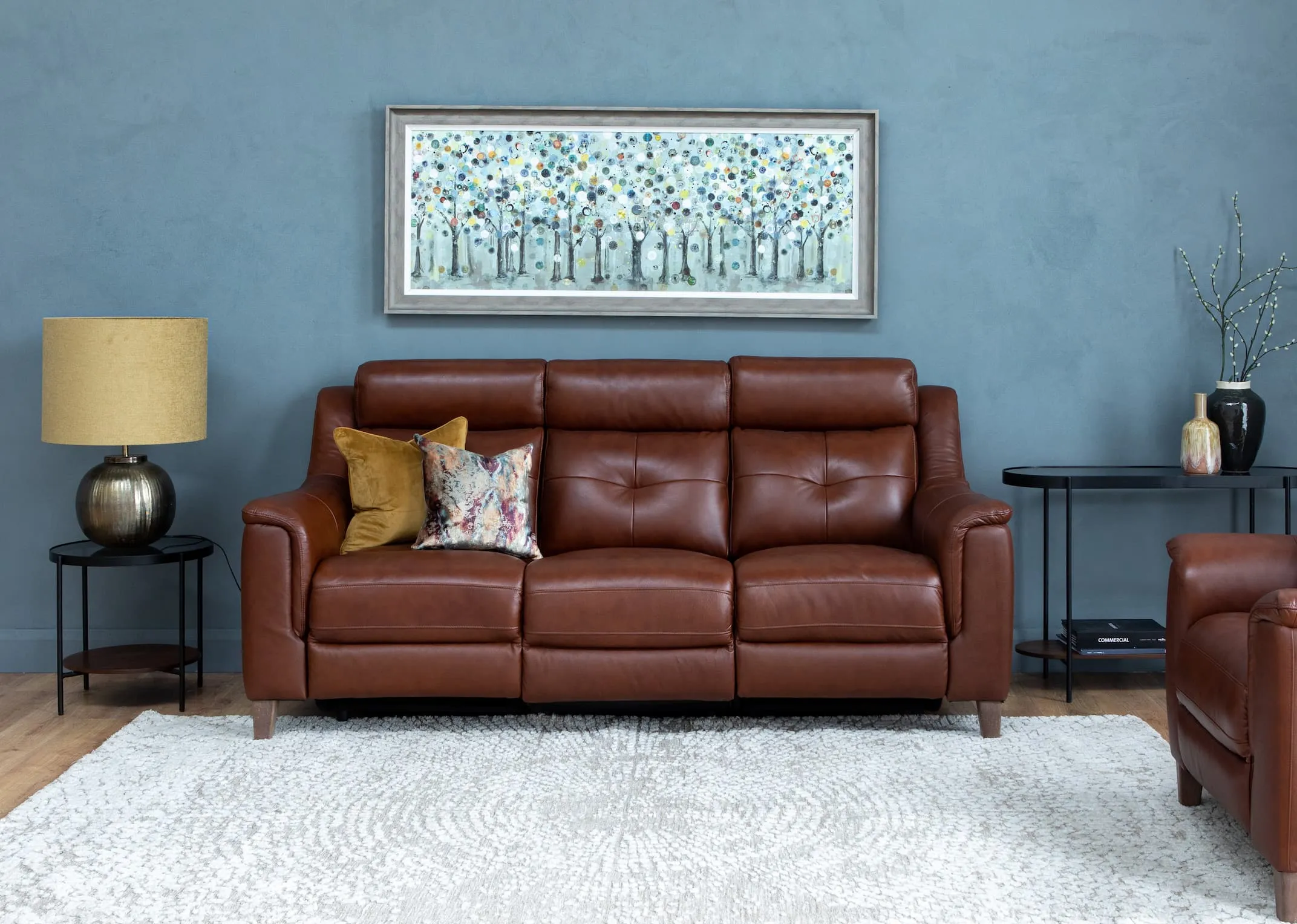 A lifestyle image of the Vantage Brown 2 Seater with glam furniture & time keeper print with Bolcho Lamp.