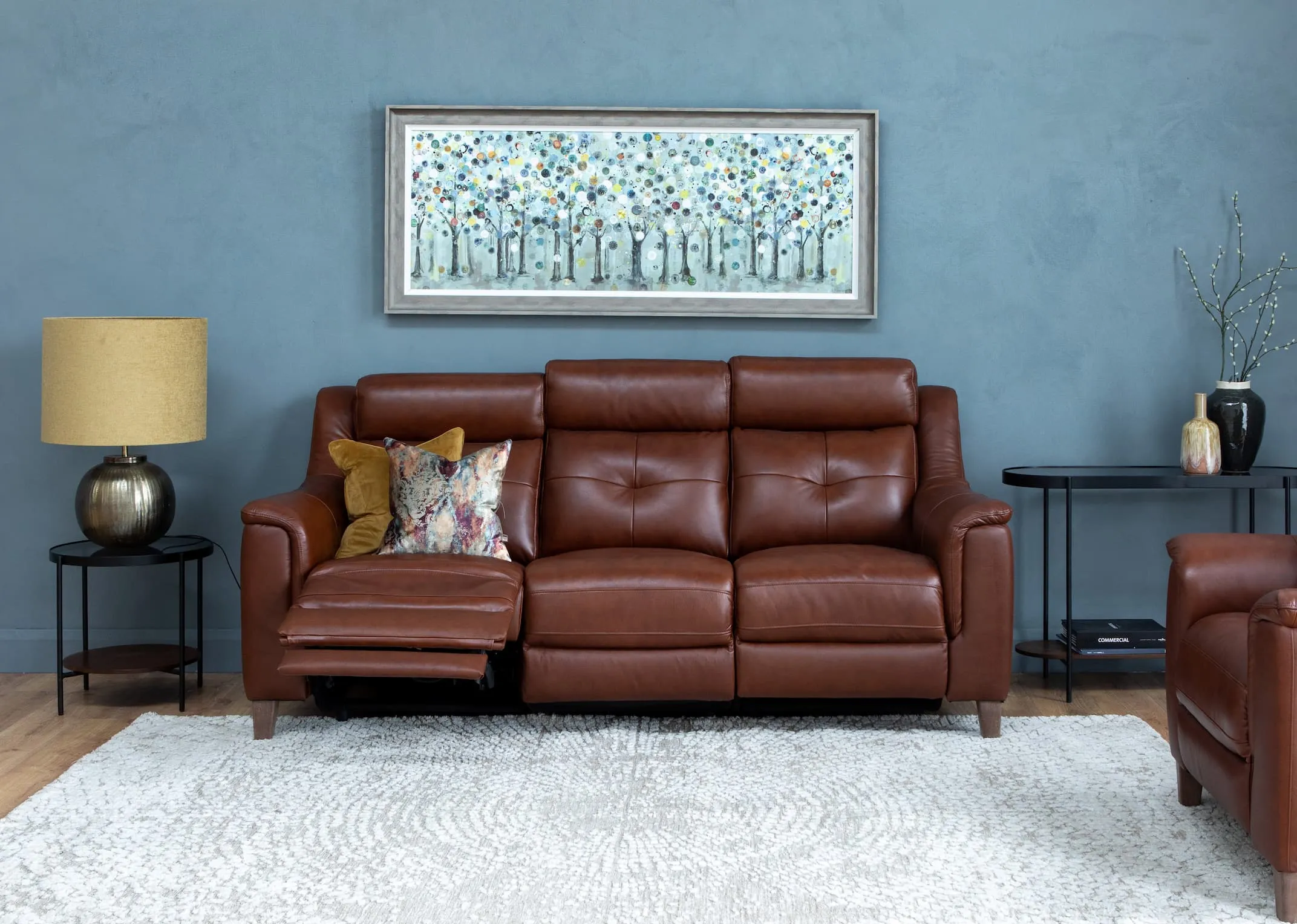 A lifestyle image of the Vantage Brown 3 Seater with glam furniture & time keeper print with Bolcho Lamp.