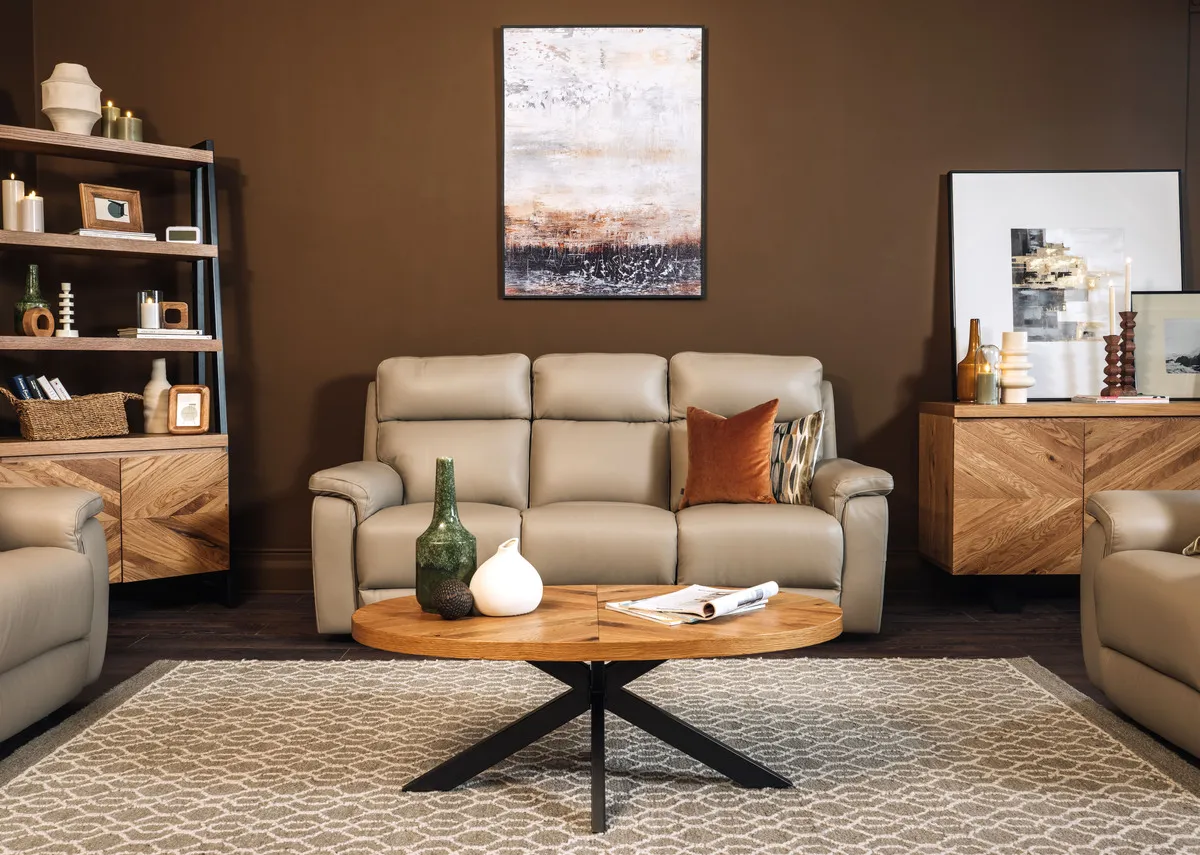 A lifestyle image of the Ellipse coffee table with Raven taupe sofas and Heiny rug.