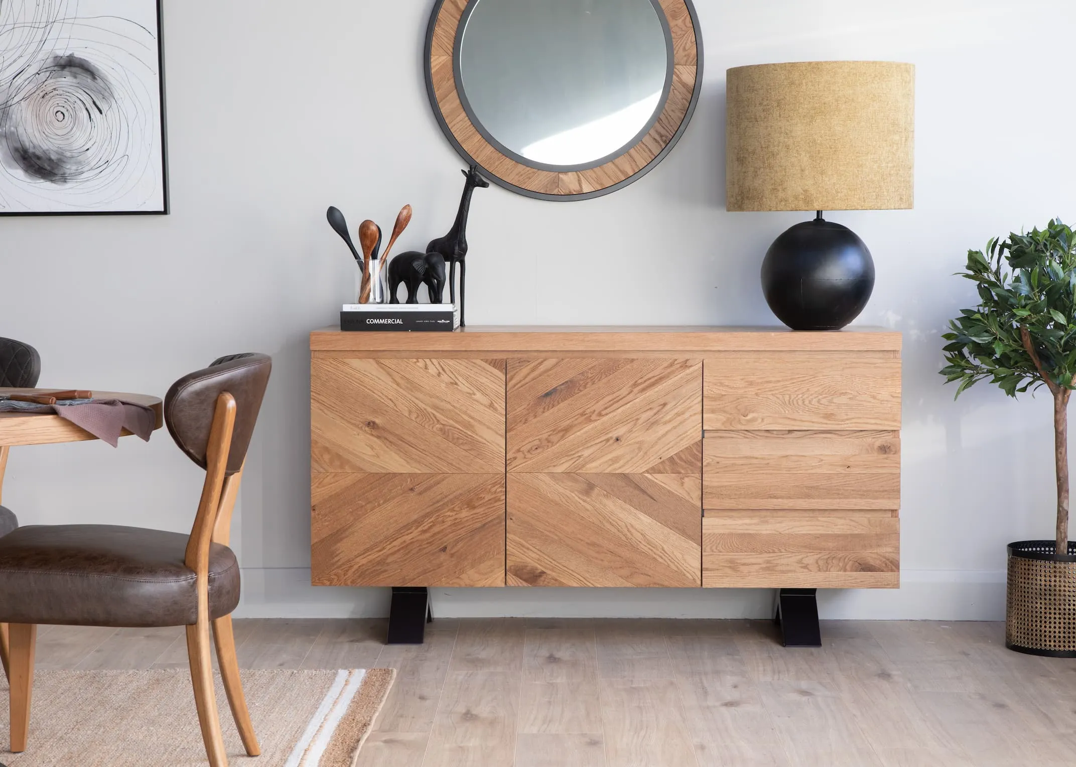 A lifestyle image of the Ellipse wide sideboard with Mirror and ebula table lamp