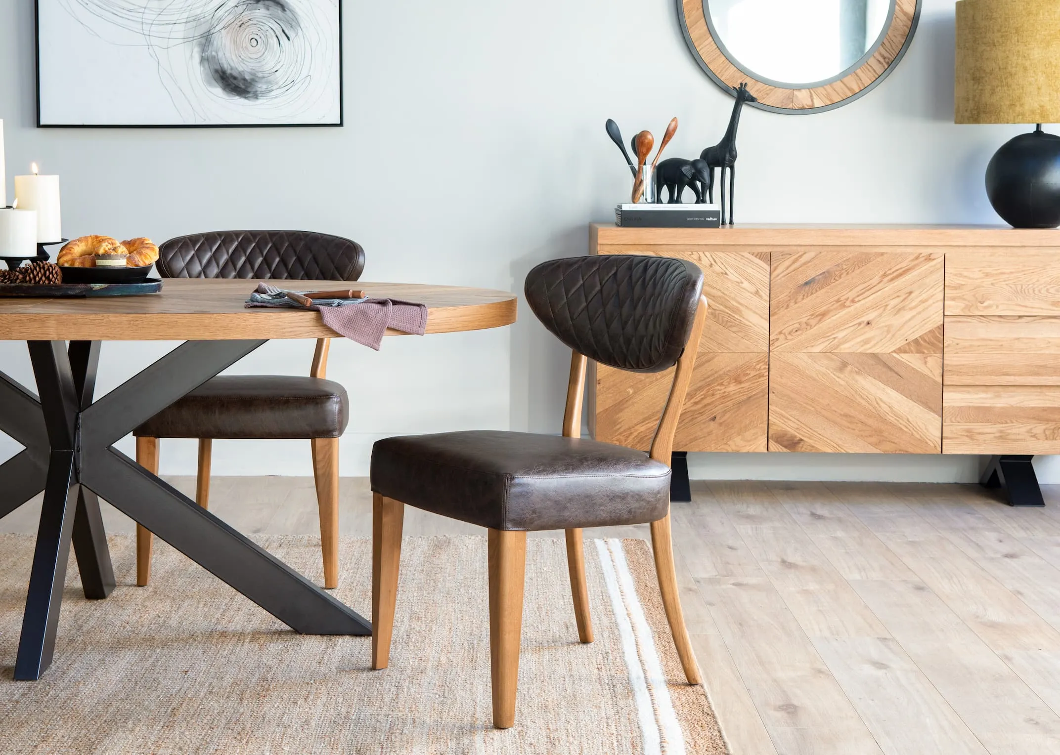 A lifestyle image of the brown faux fabric Margot dining chair with the ellipse dining range from EZ Living Furniture.