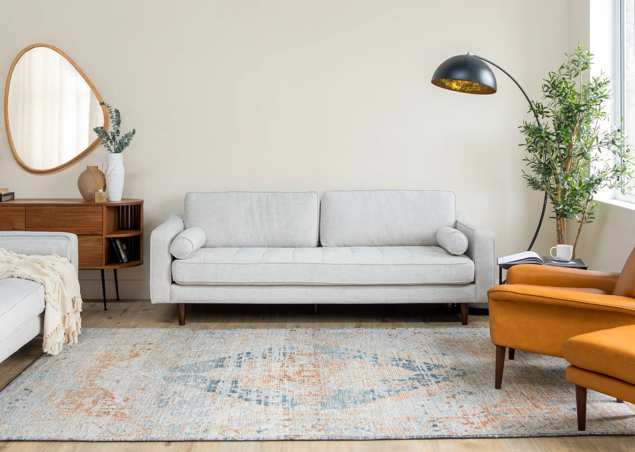 A lifestyle image of the Maxima Rug with Genoa Sofa & Donna chairs