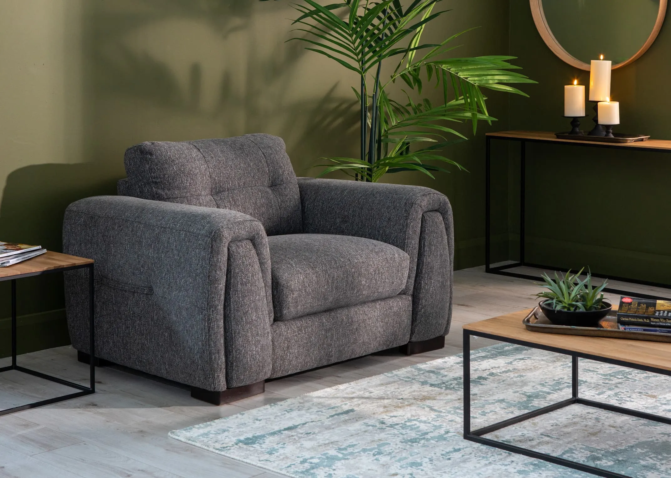 A lifestyle image of the Cliff Armchair with aston tables & modesto grey rug