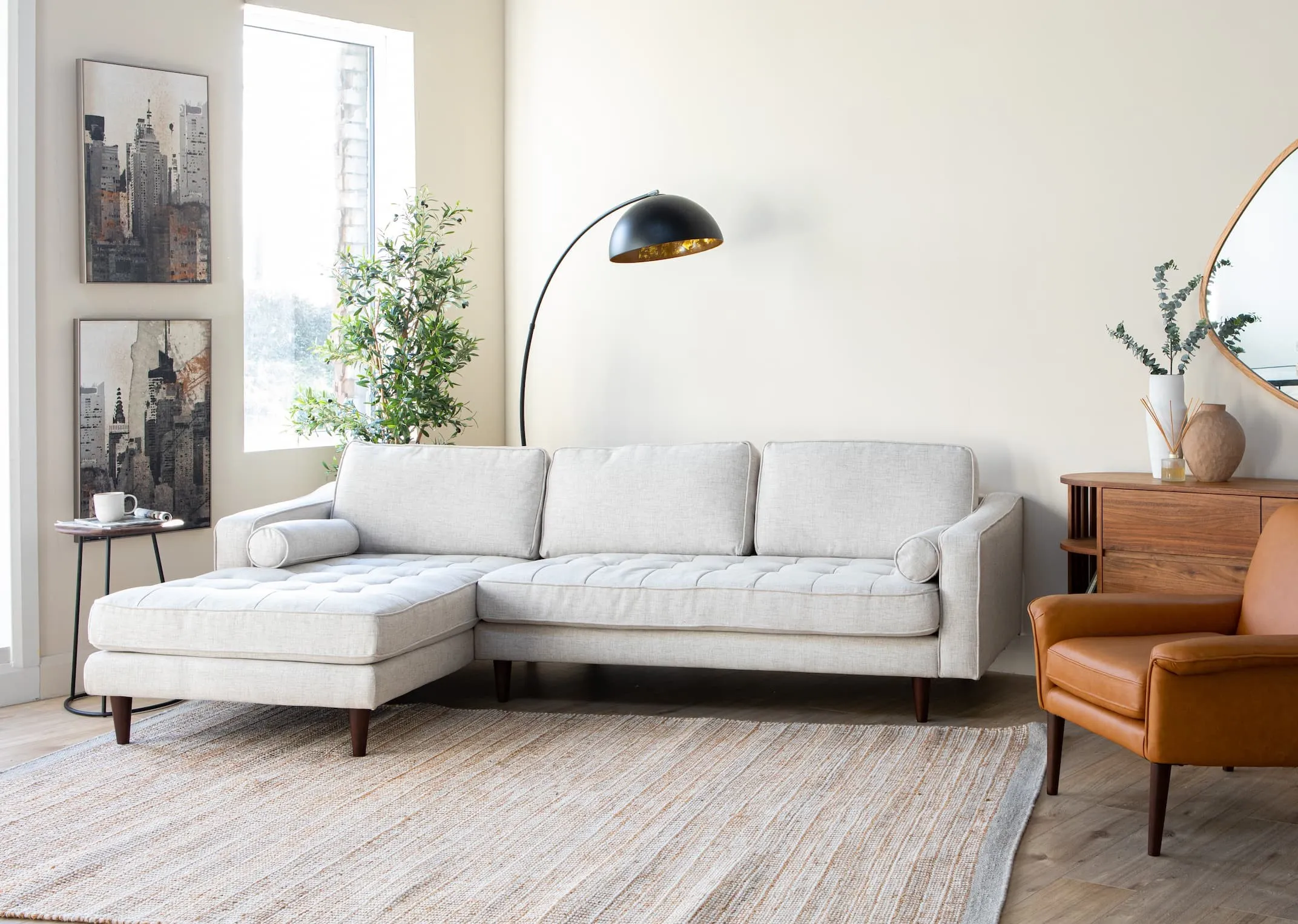 A lifestyle image of the Genoa Corner chaise with Donna Leather armchair & New York Highlife prints.